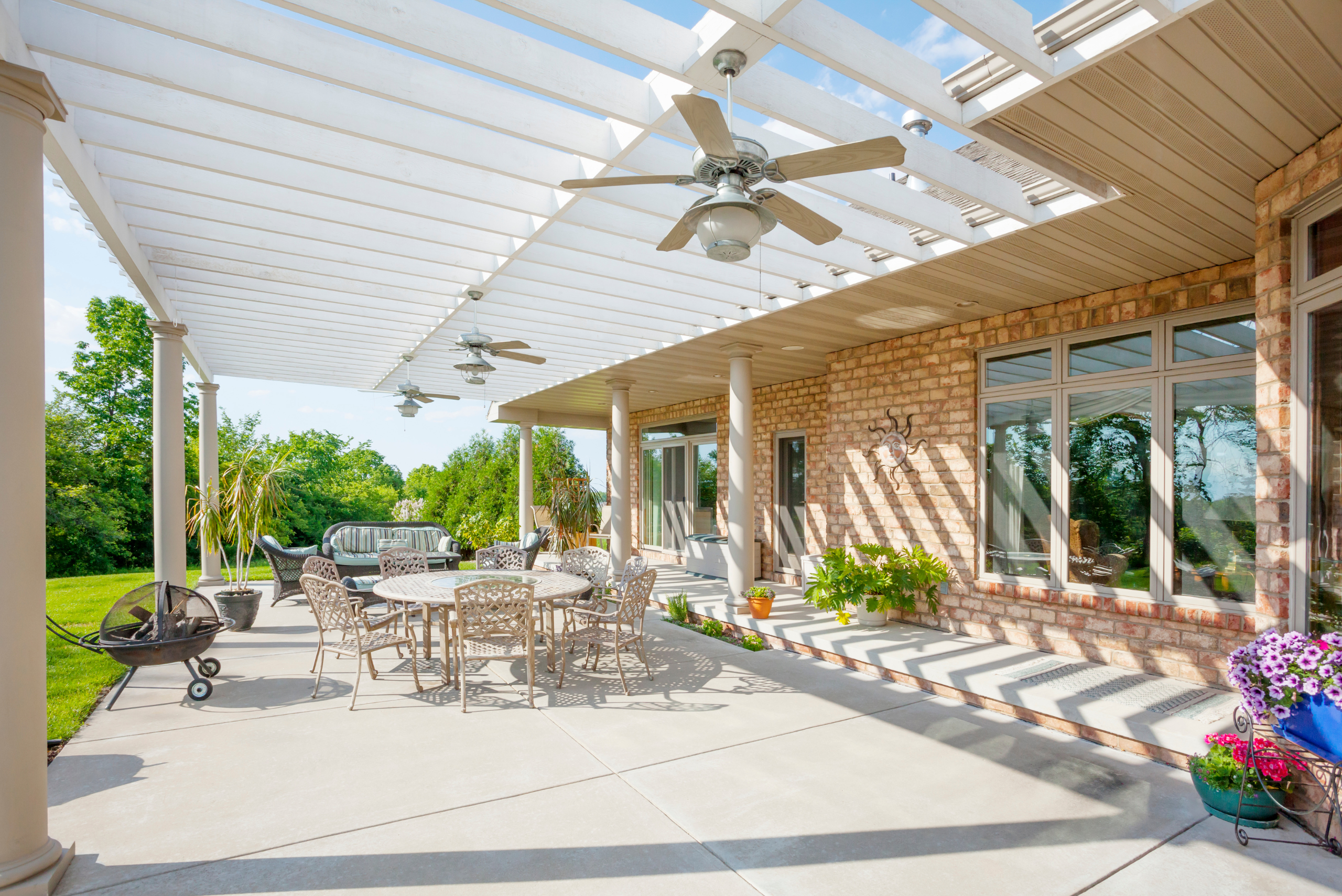 Backyard pergola attached to the house and mounts outdoor fans.