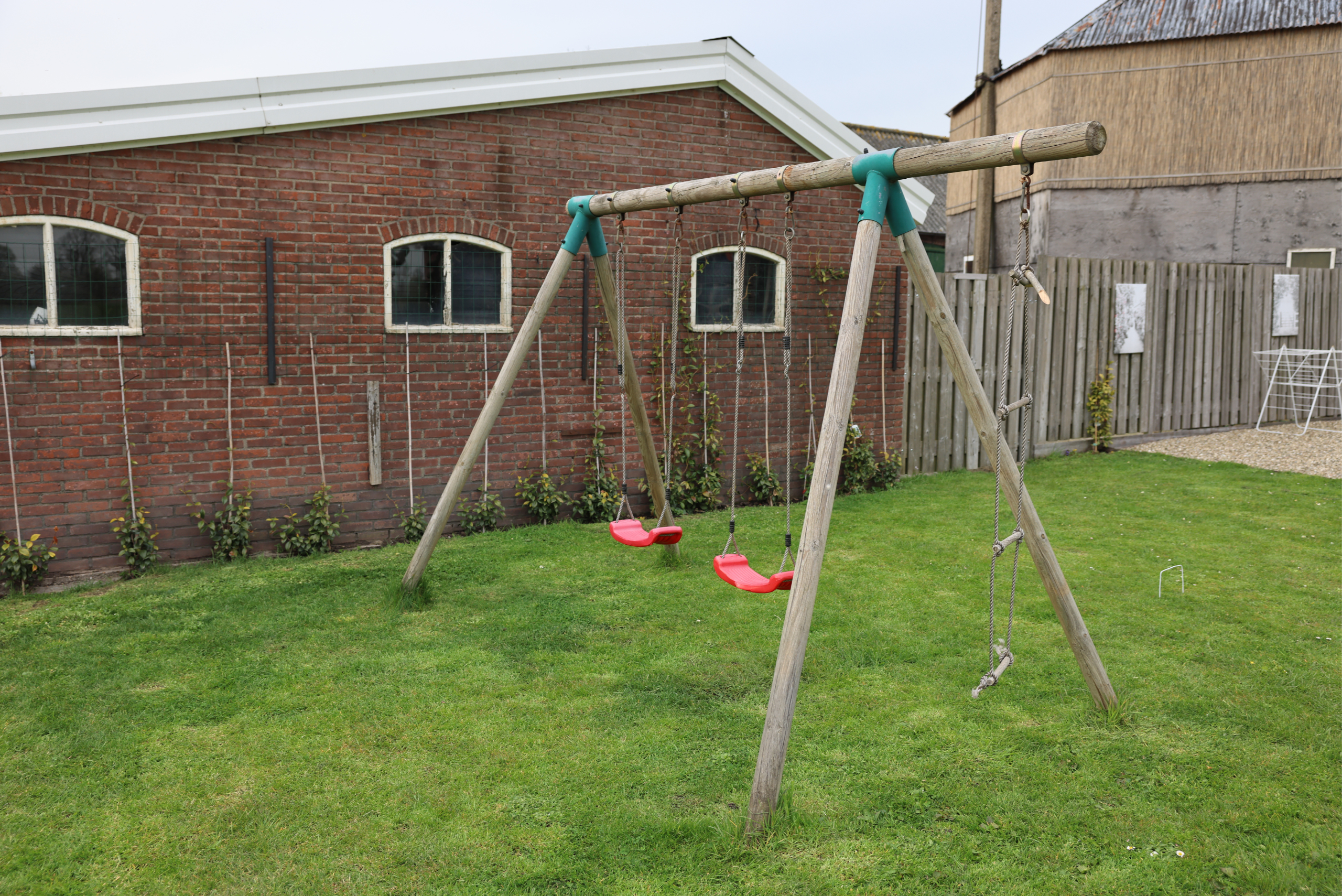 Wooden swing set in a backyard.