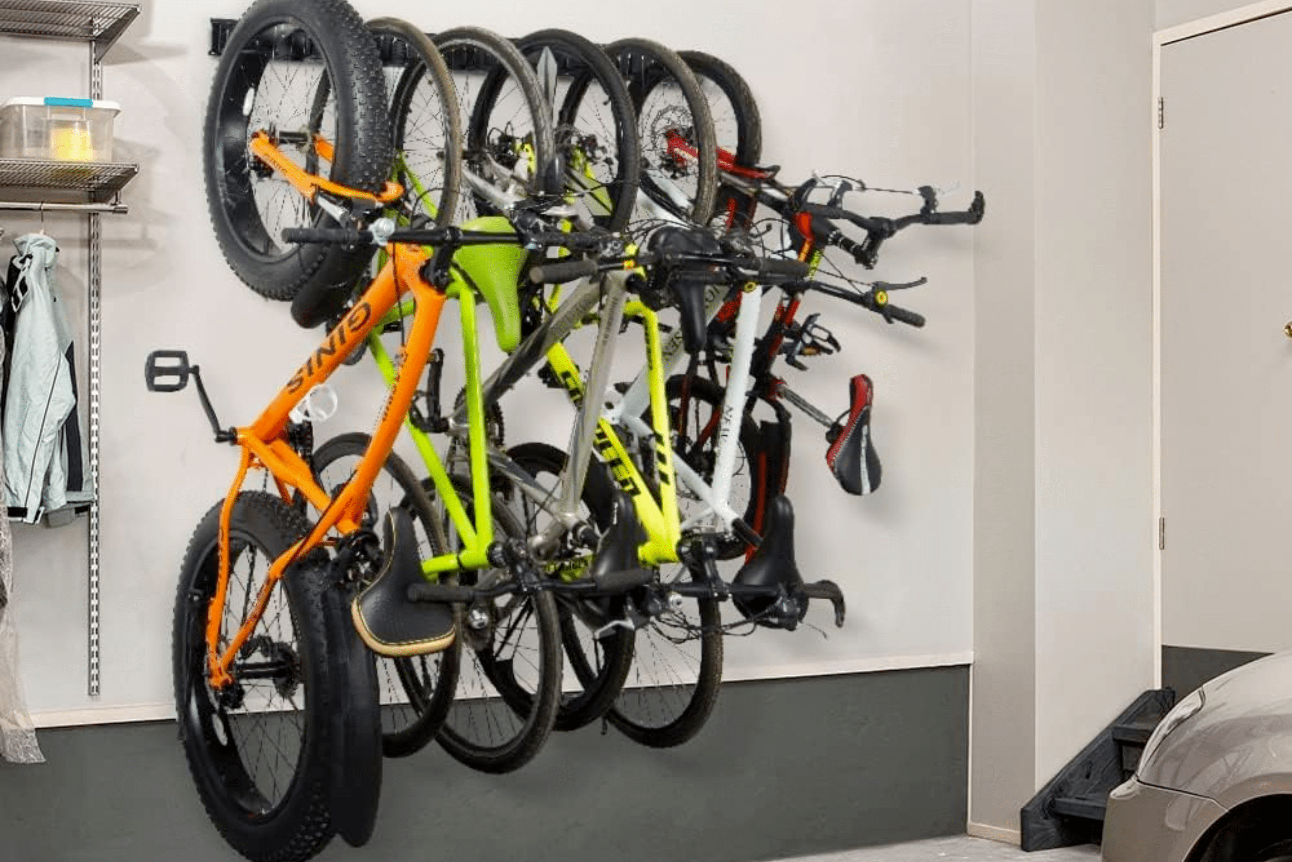 Bikes mounted on a wall garage bike rack.