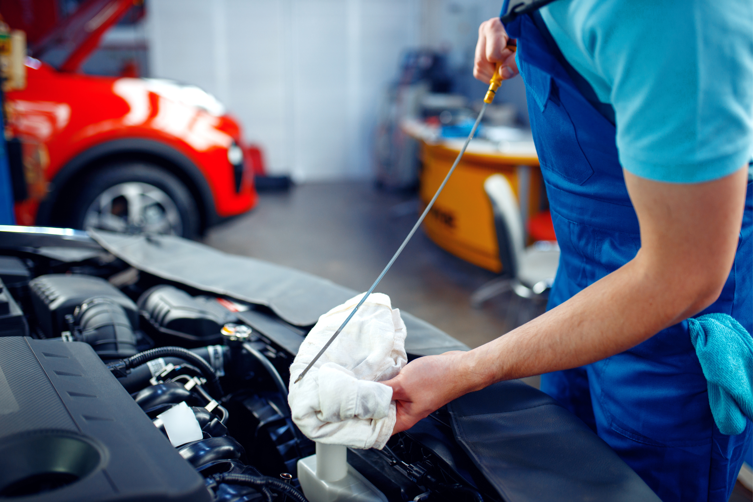 Person checking the engine oil after changing the oil.