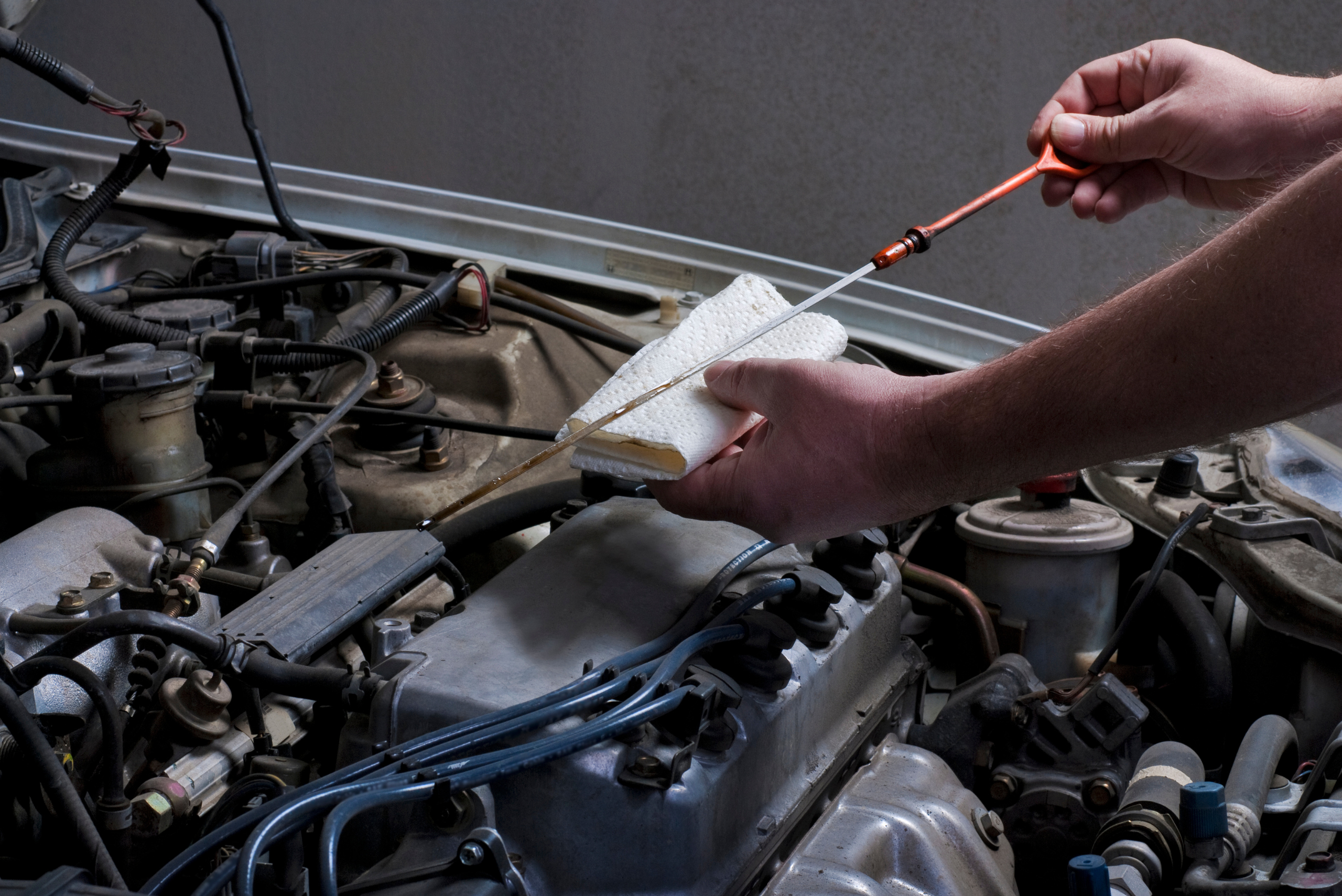 Checking the engine oil level before changing it.