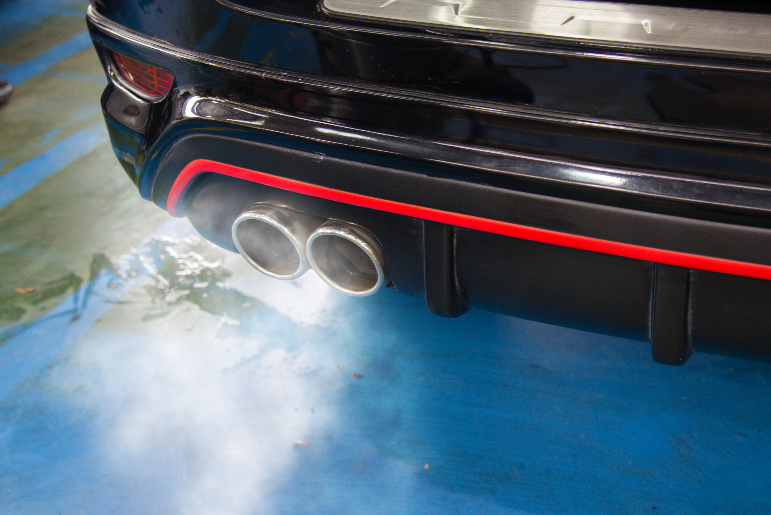 Closeup of car's exhaust while the engine is running.
