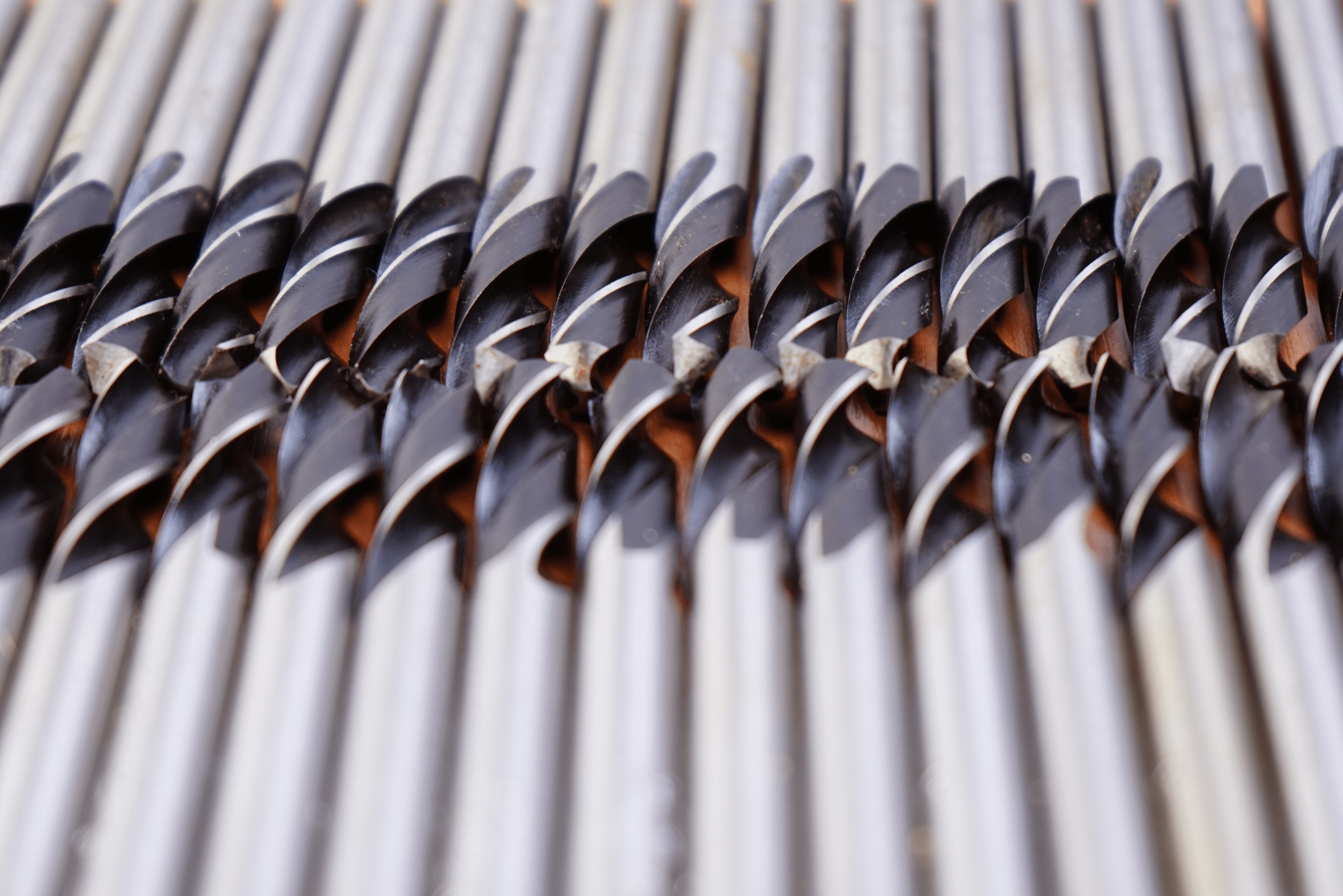 Drill bits for metal laid out flat on table.