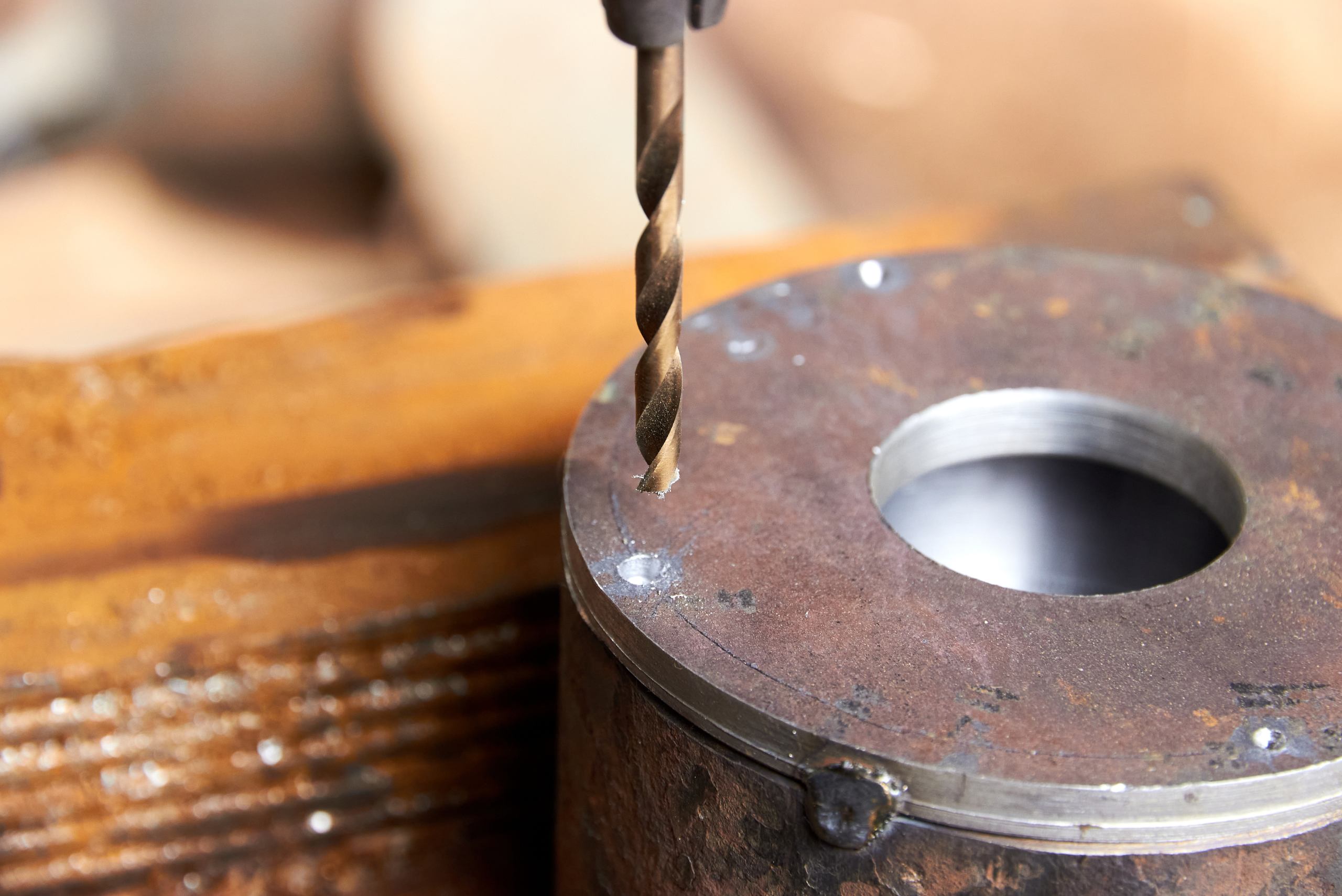 Metal drill bit in a drill press.