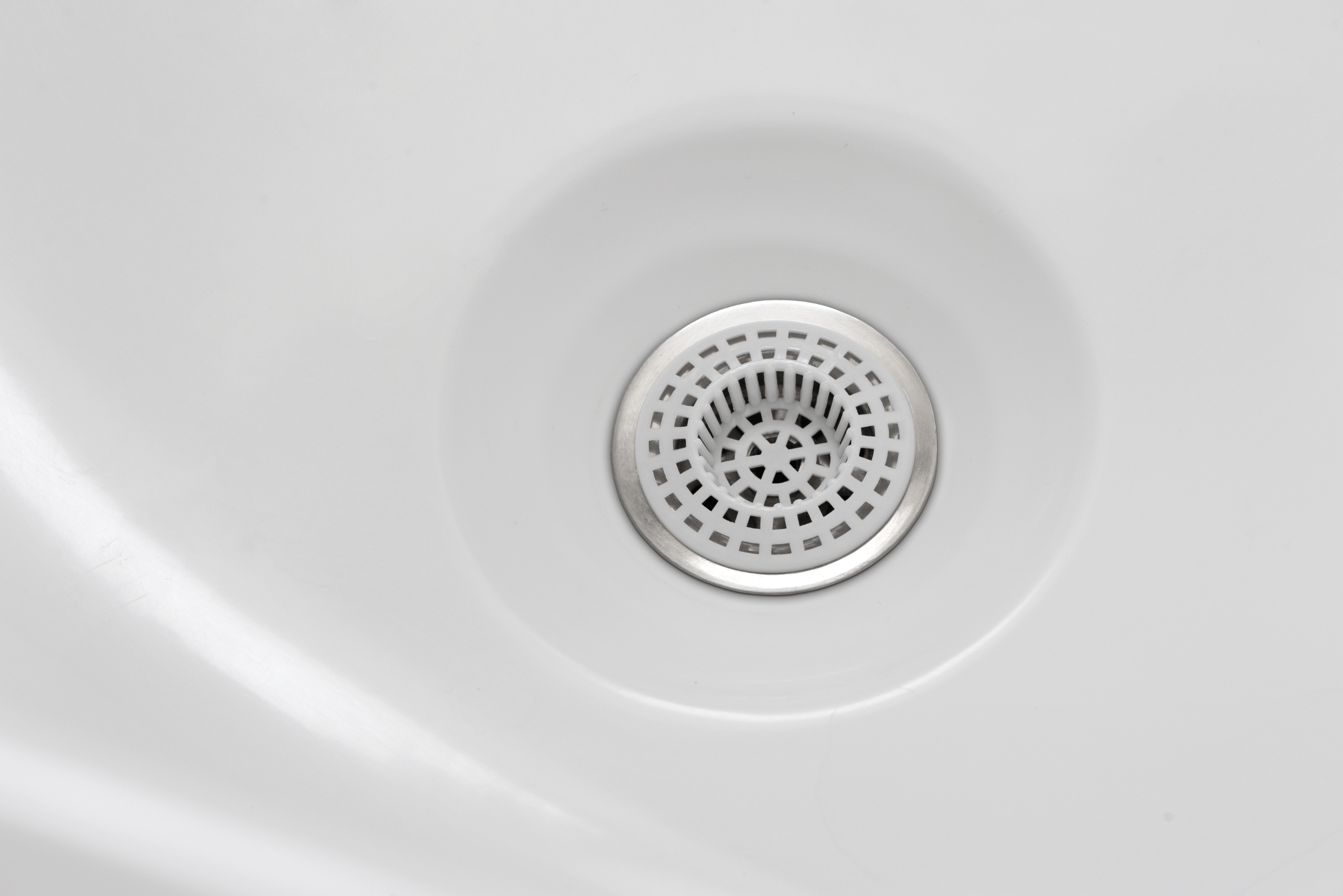 Closeup of a bathtub drain.