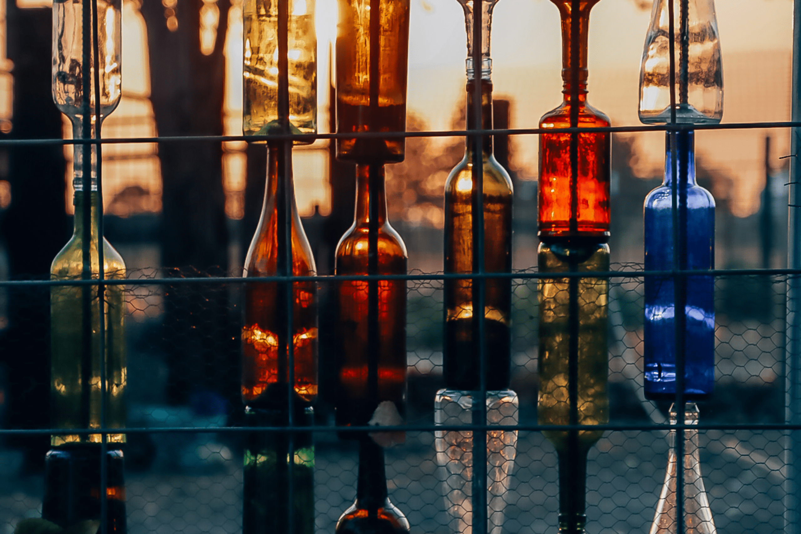 Fence with bottles put through it as decorative pieces.