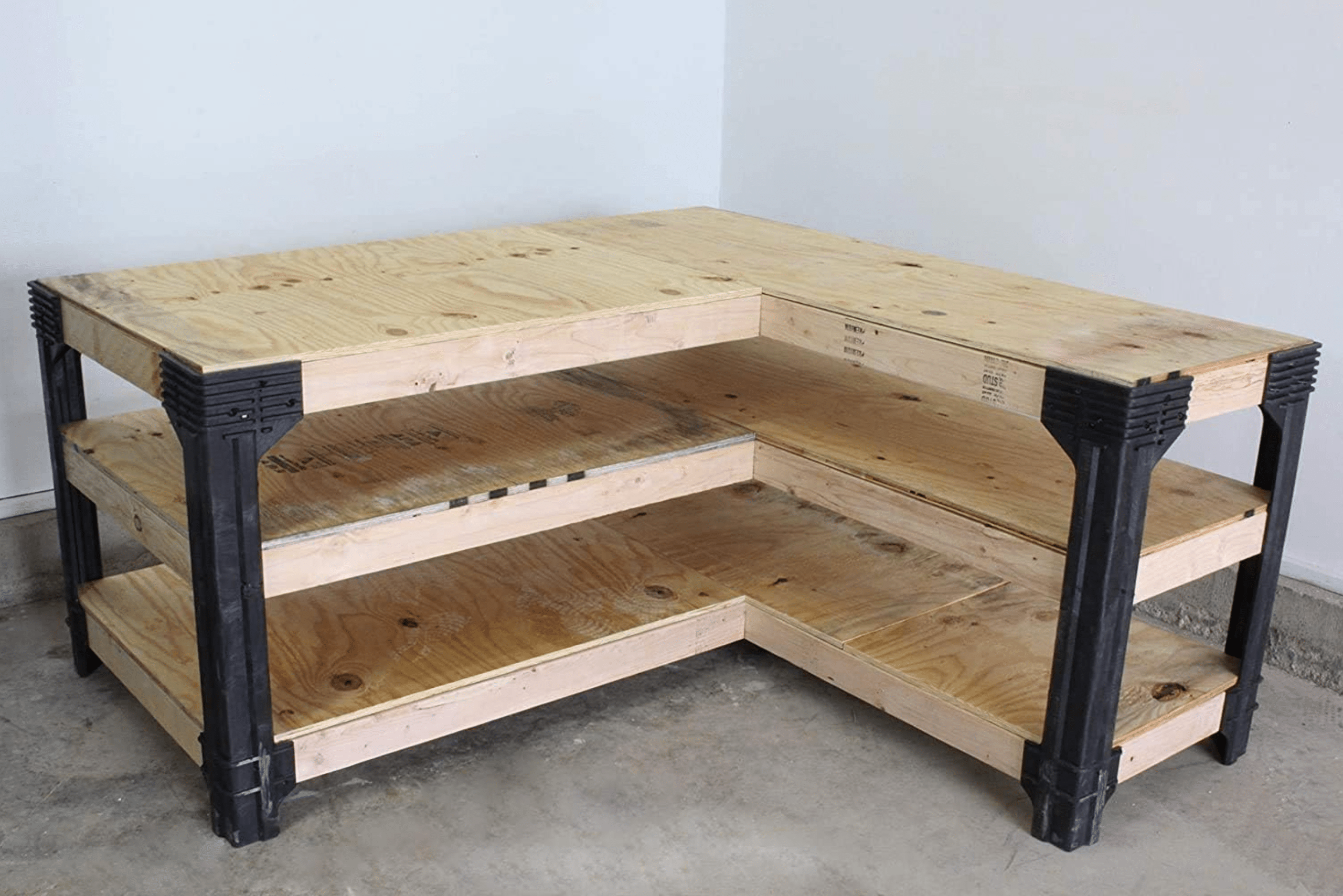 L-shaped workbench made of wood for the tops and metal frame.