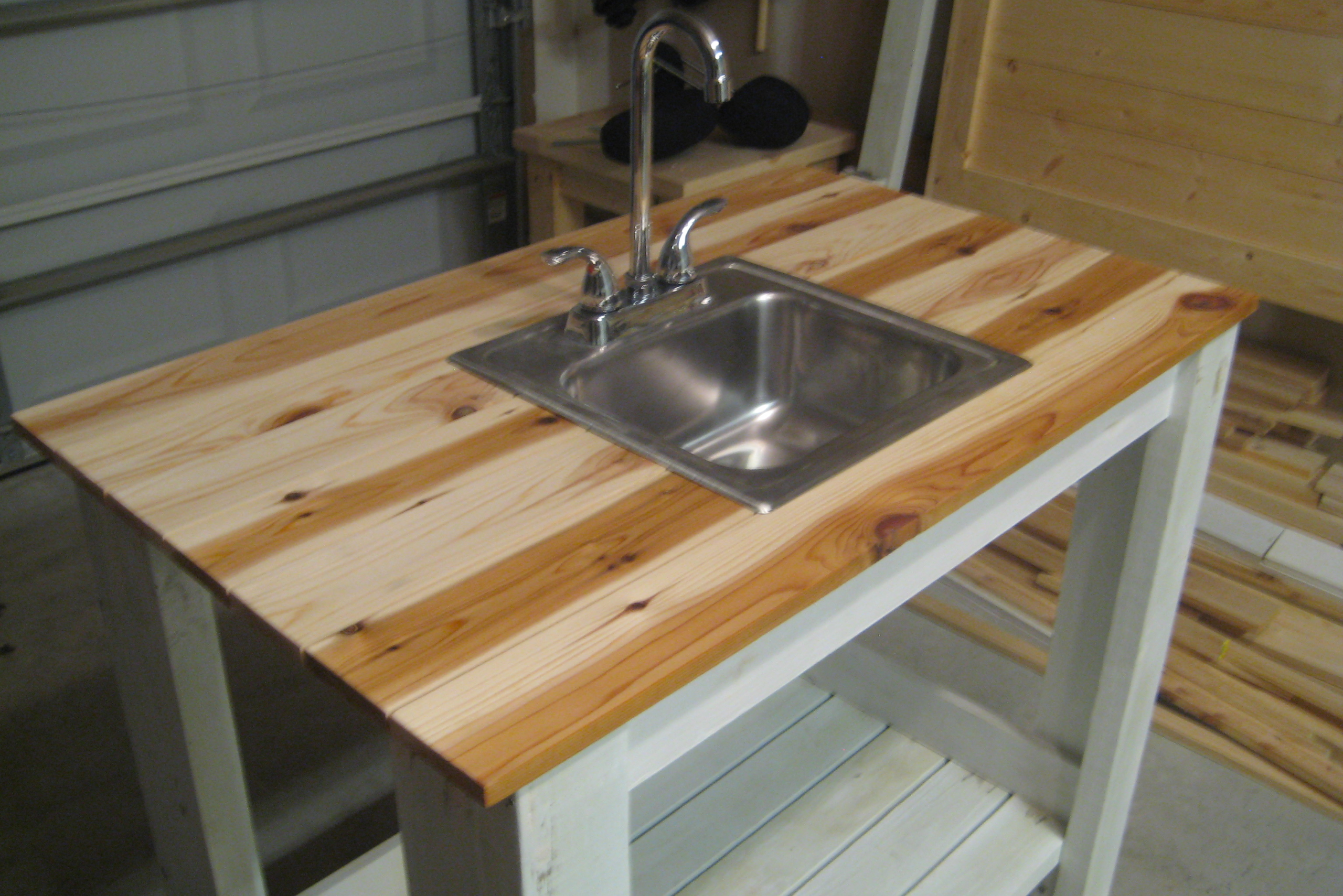 A wooden outdoor sink and prep station.