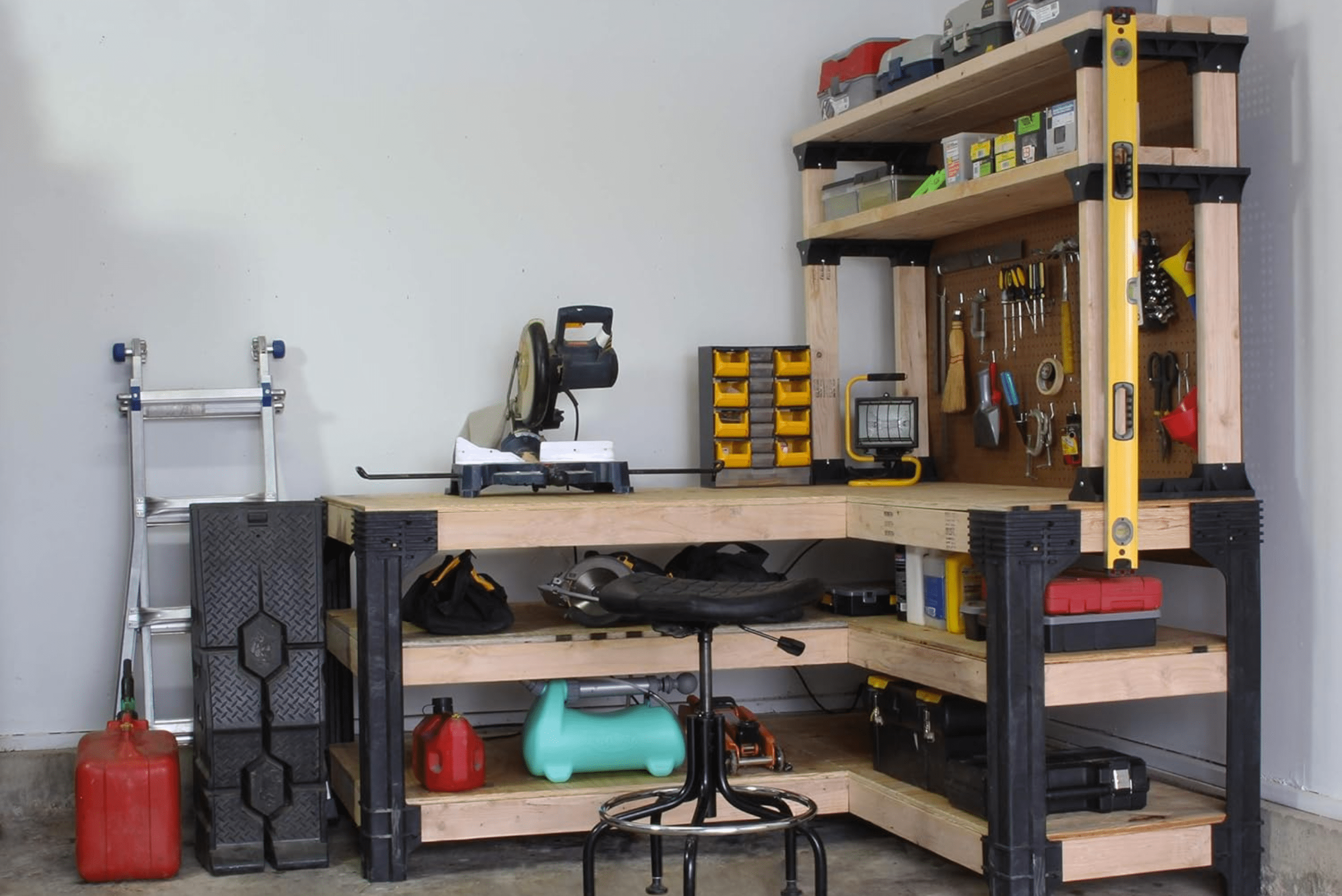 L-shaped workbench with a pegboard and shelf.