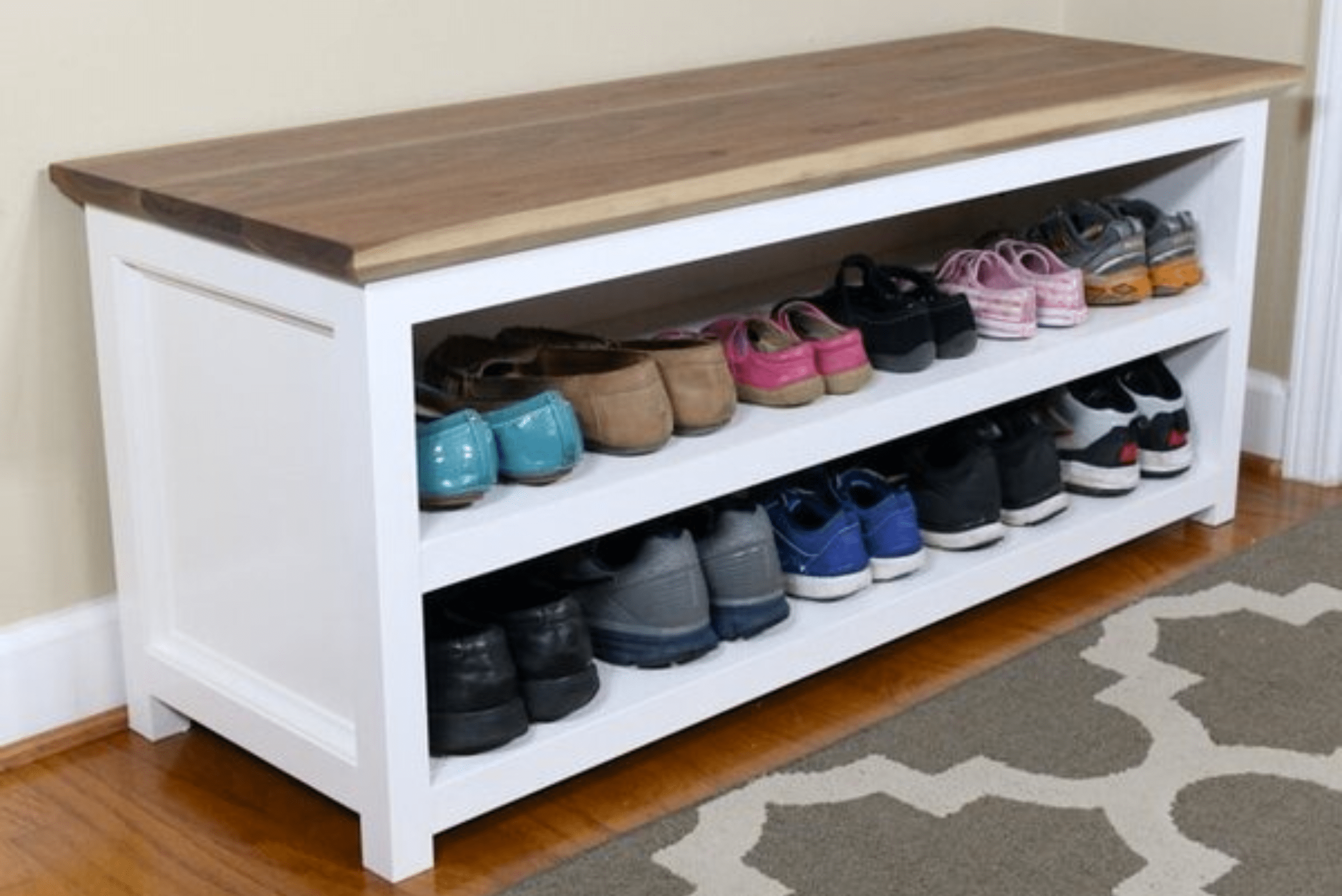 Wooden DIY shoe rack with white frame and natural wood top.