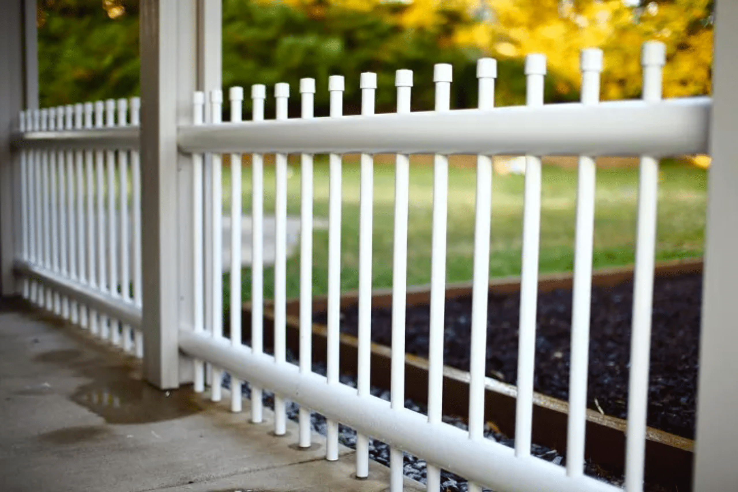 A fence made of white PCV piping.