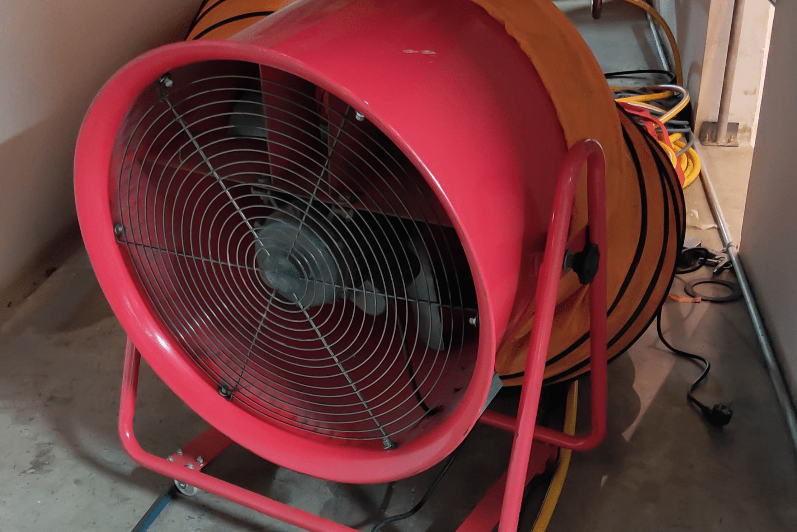 Tube fan that is red connected to an orange tube.