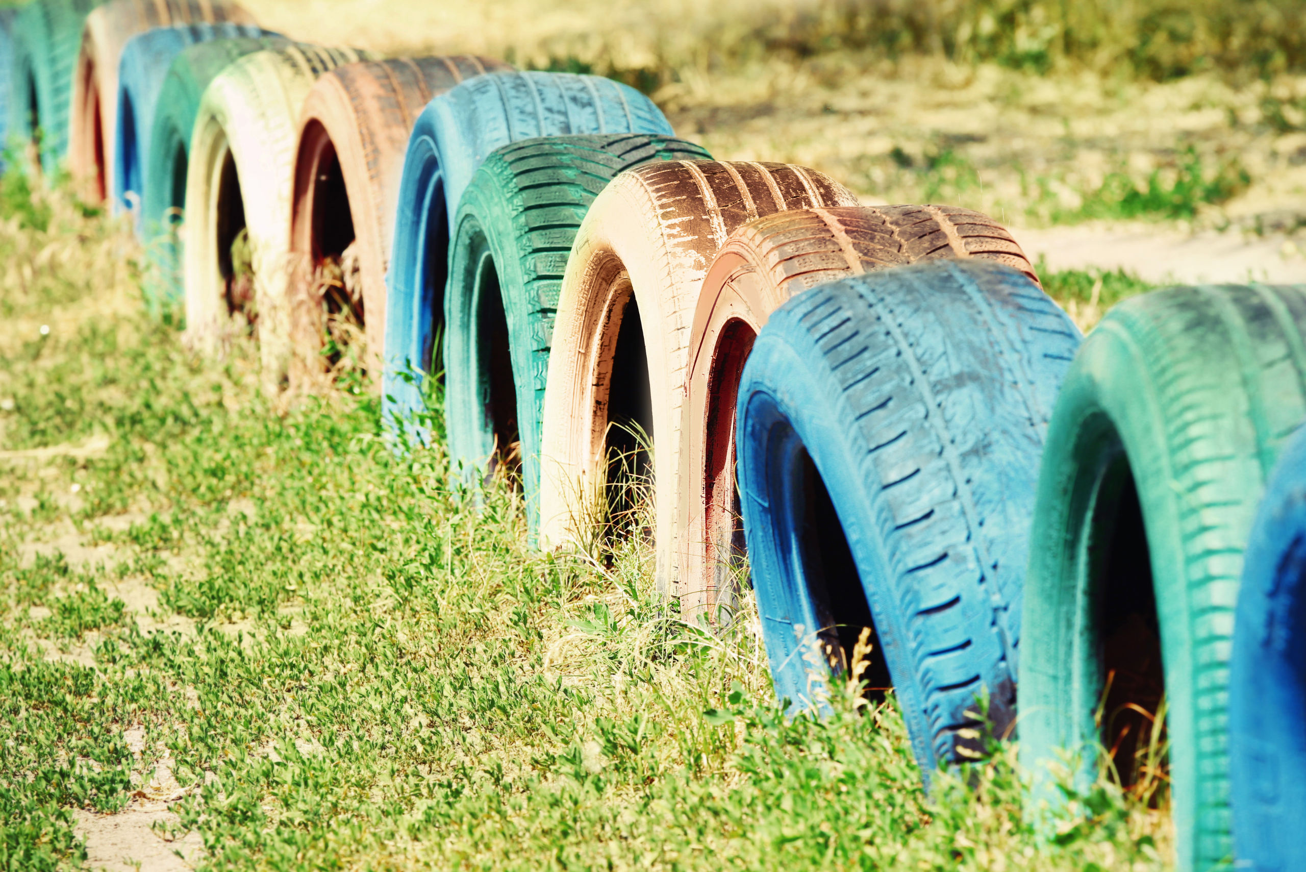 Tires cut in half and painted to create a small fence.