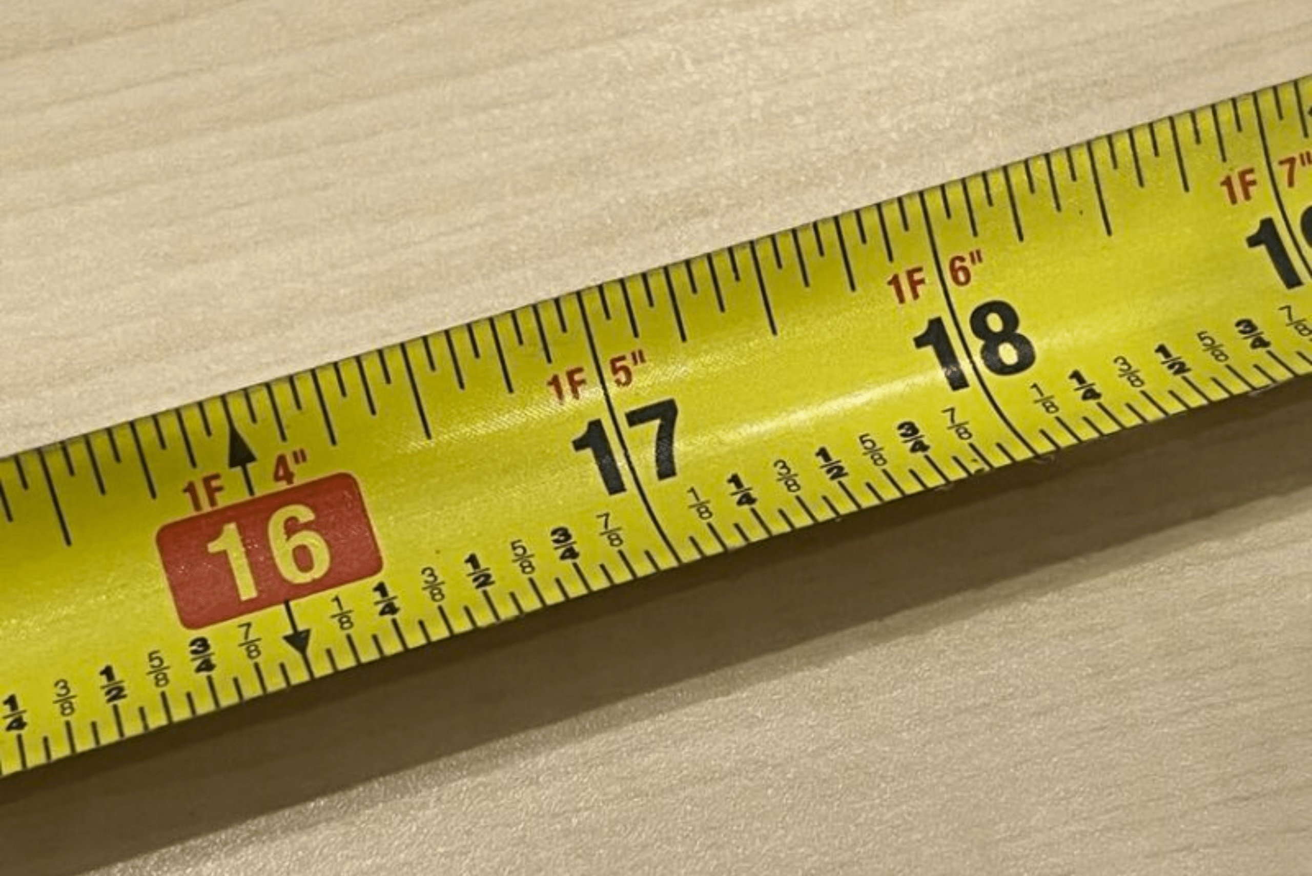 A tape measure marks with red highlight on 16 inches.