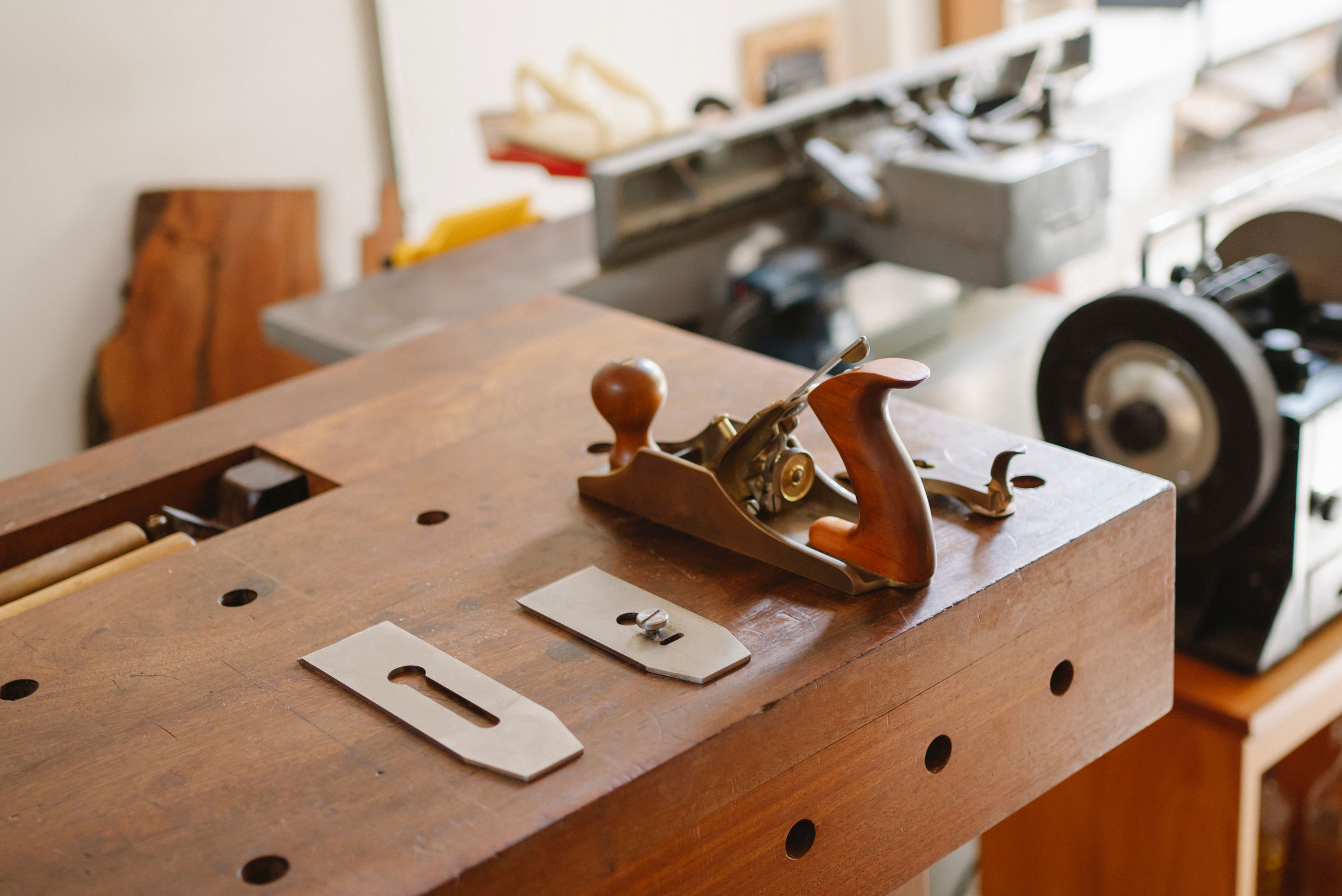 Carpenter workbench with a hand planer on it.