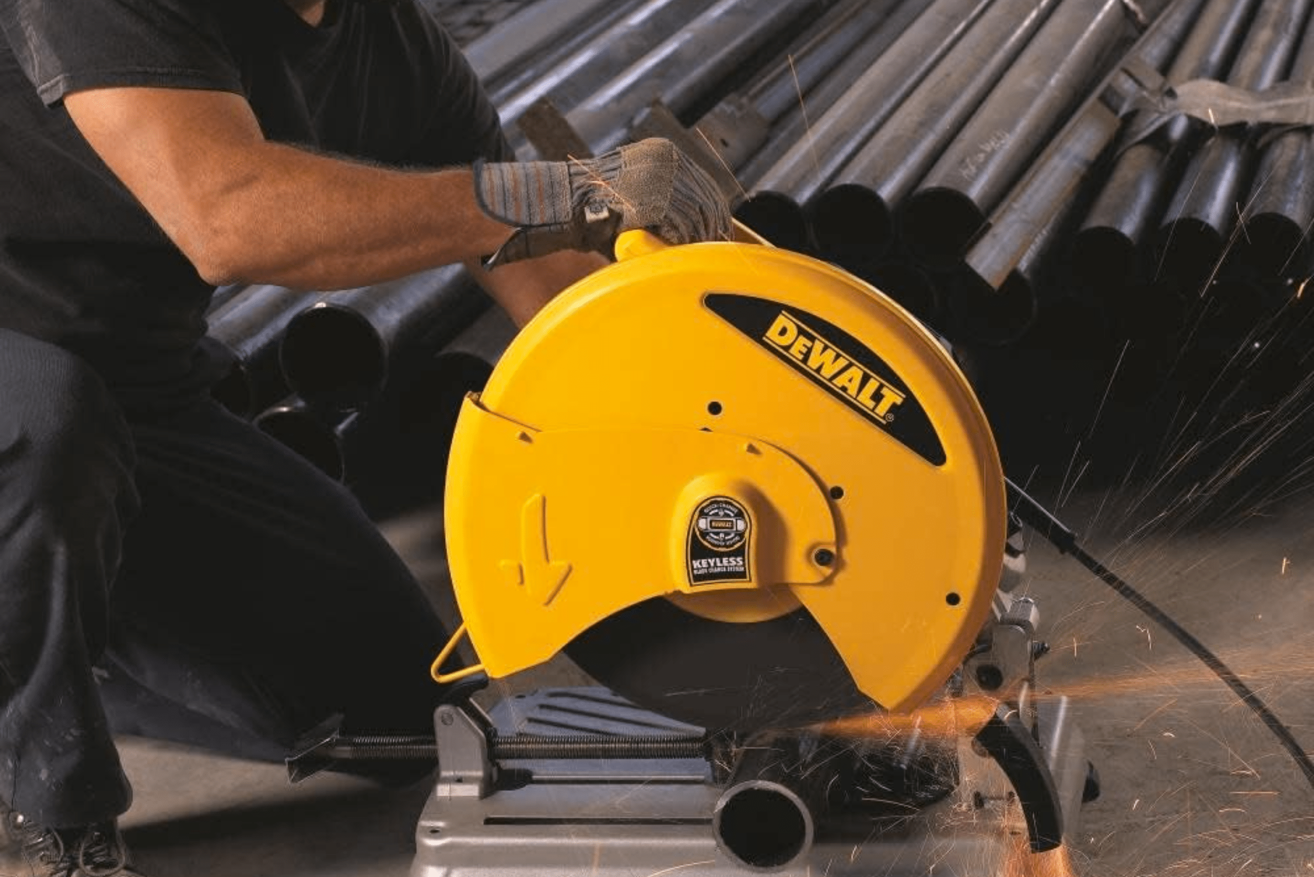 A yellow Dewalt chop saw cutting metal pipes.