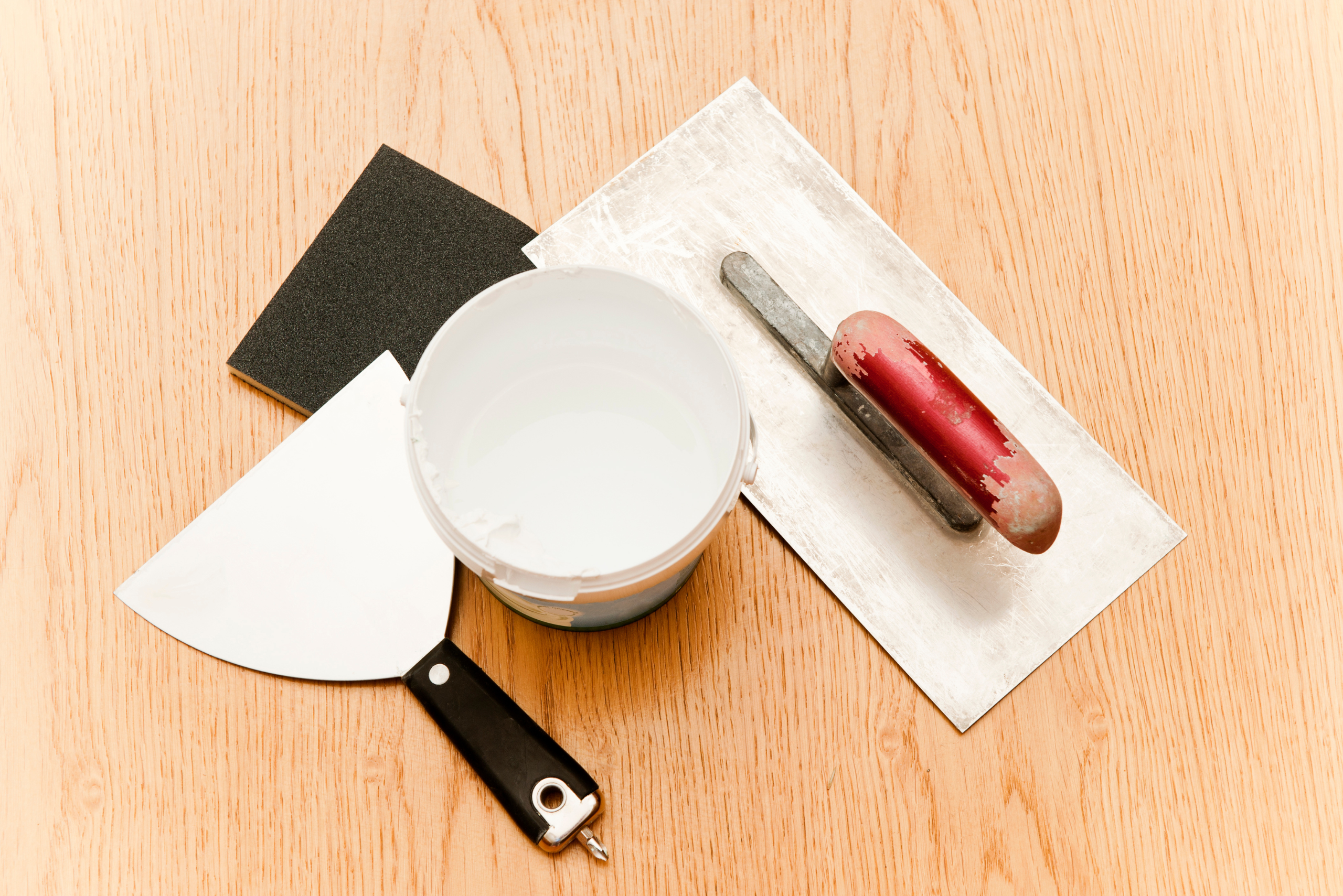 An assortment of tools and materials for repairing drywall damage.