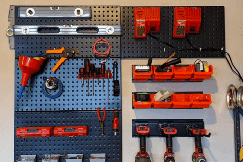 An assortment of power tools stored on a pegboard.