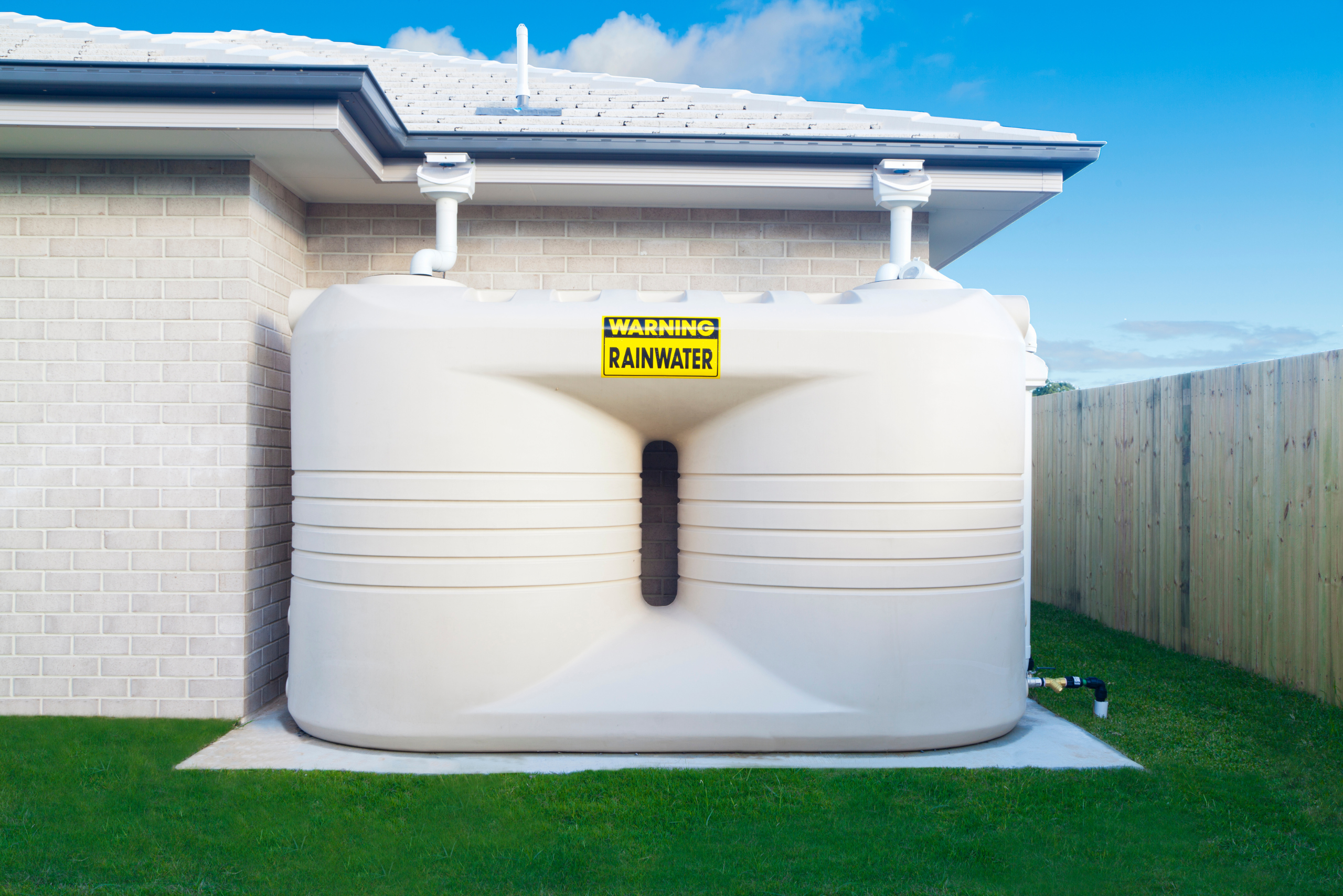Large double rain barrel system for collecting water from the roof.