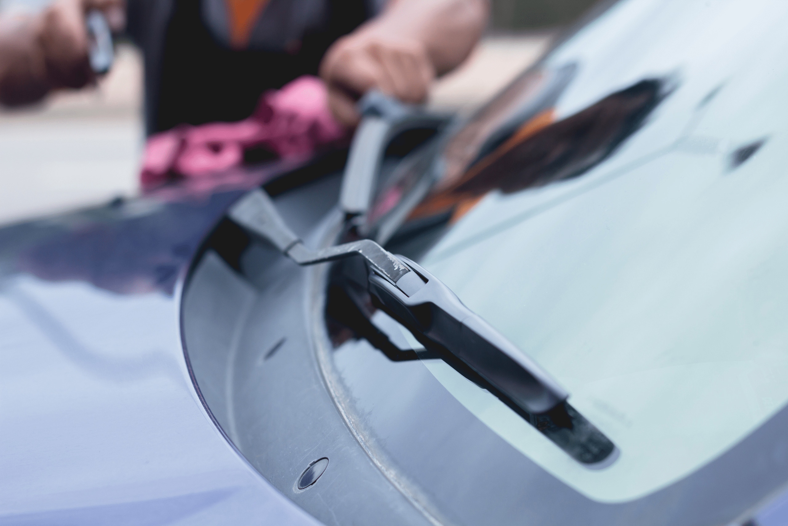 A closeup of a car's wiper blades and windshield.