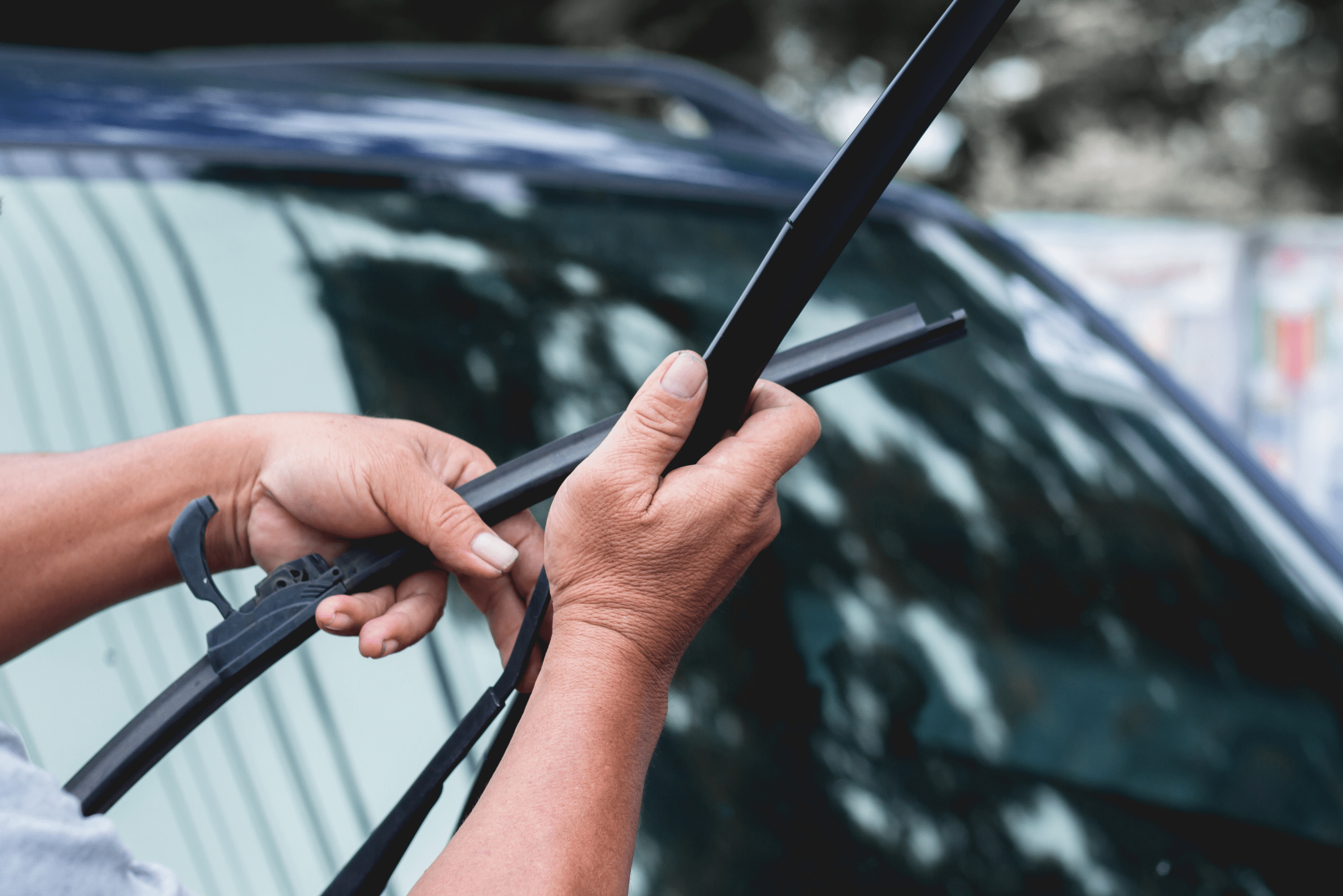 Securing the new wiper blade back onto the wiper arm.
