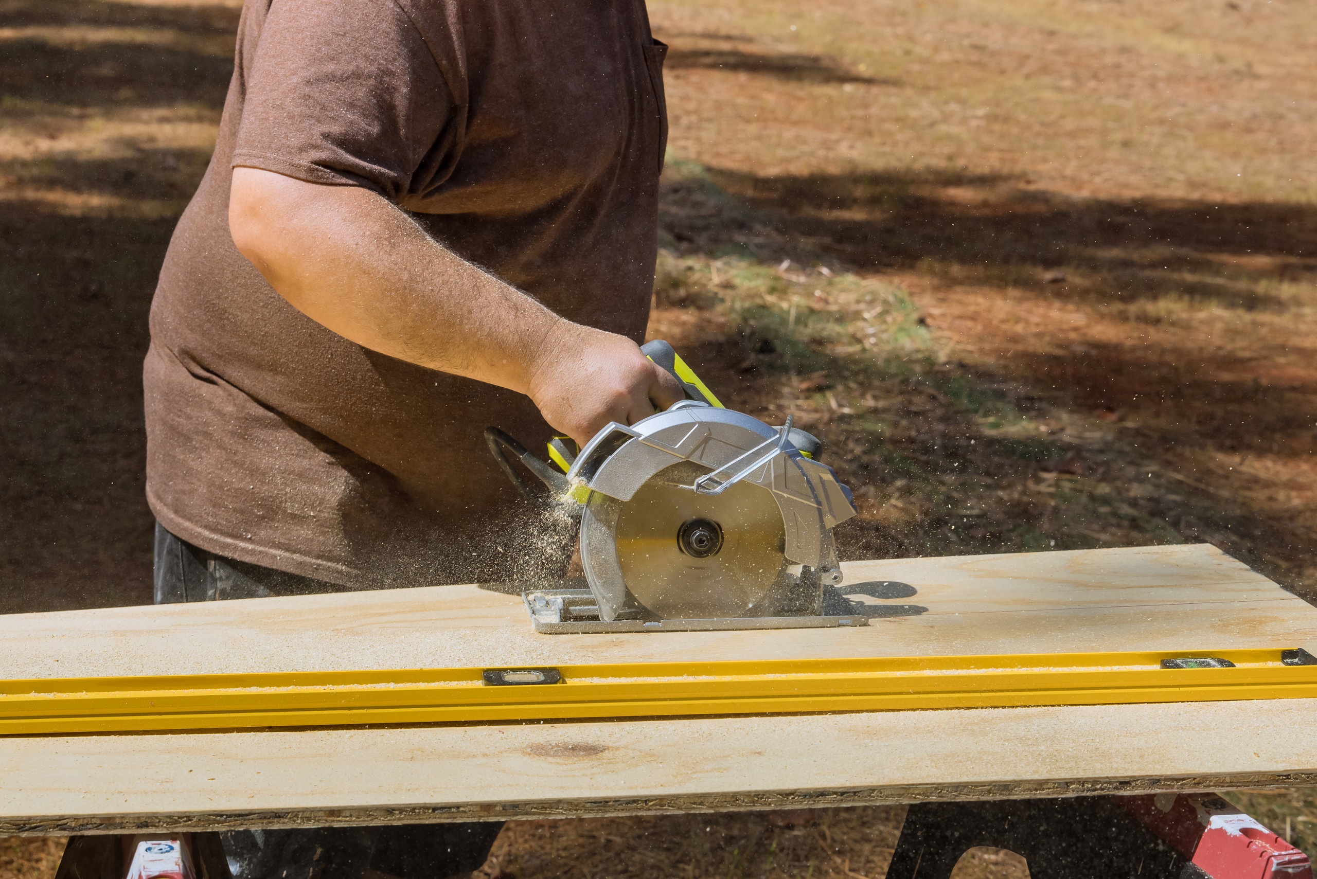Person cutting a plywood DIY router top using a circular saw.