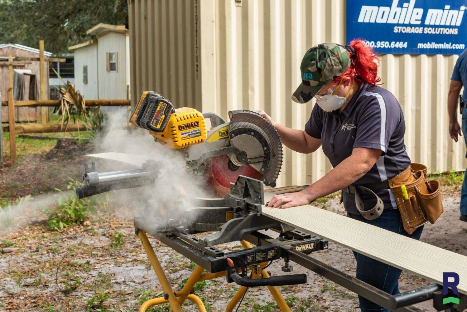 woman cutting hardie board with a circular saw