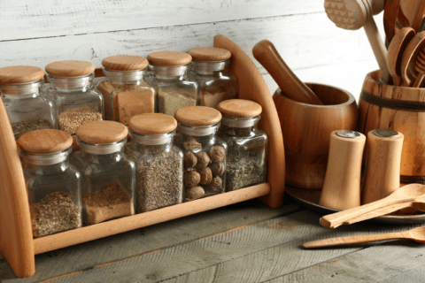 A wooden rack with spice jars.