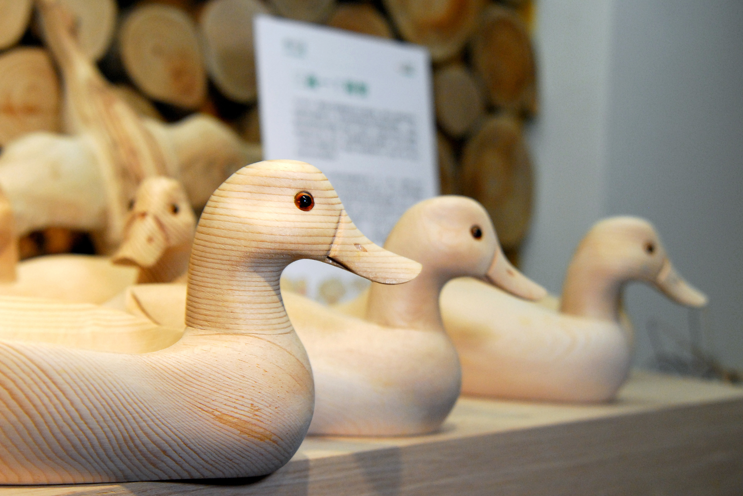 An assortment of finished carved wooden ducks.