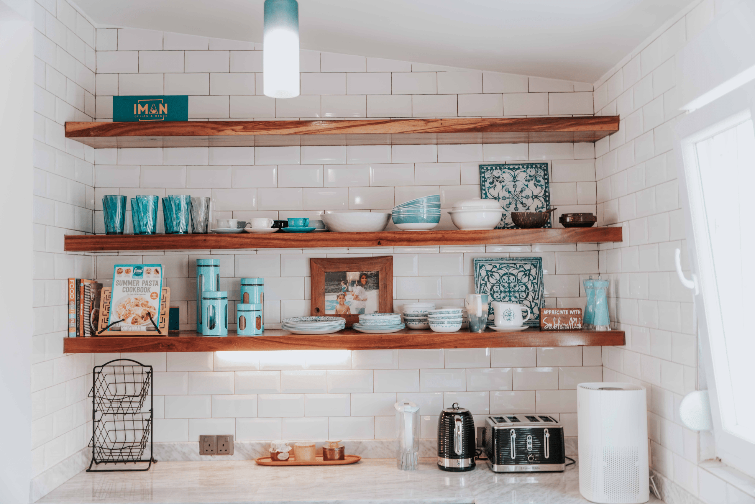 Kitchen floating shelves holding various kitchen items.