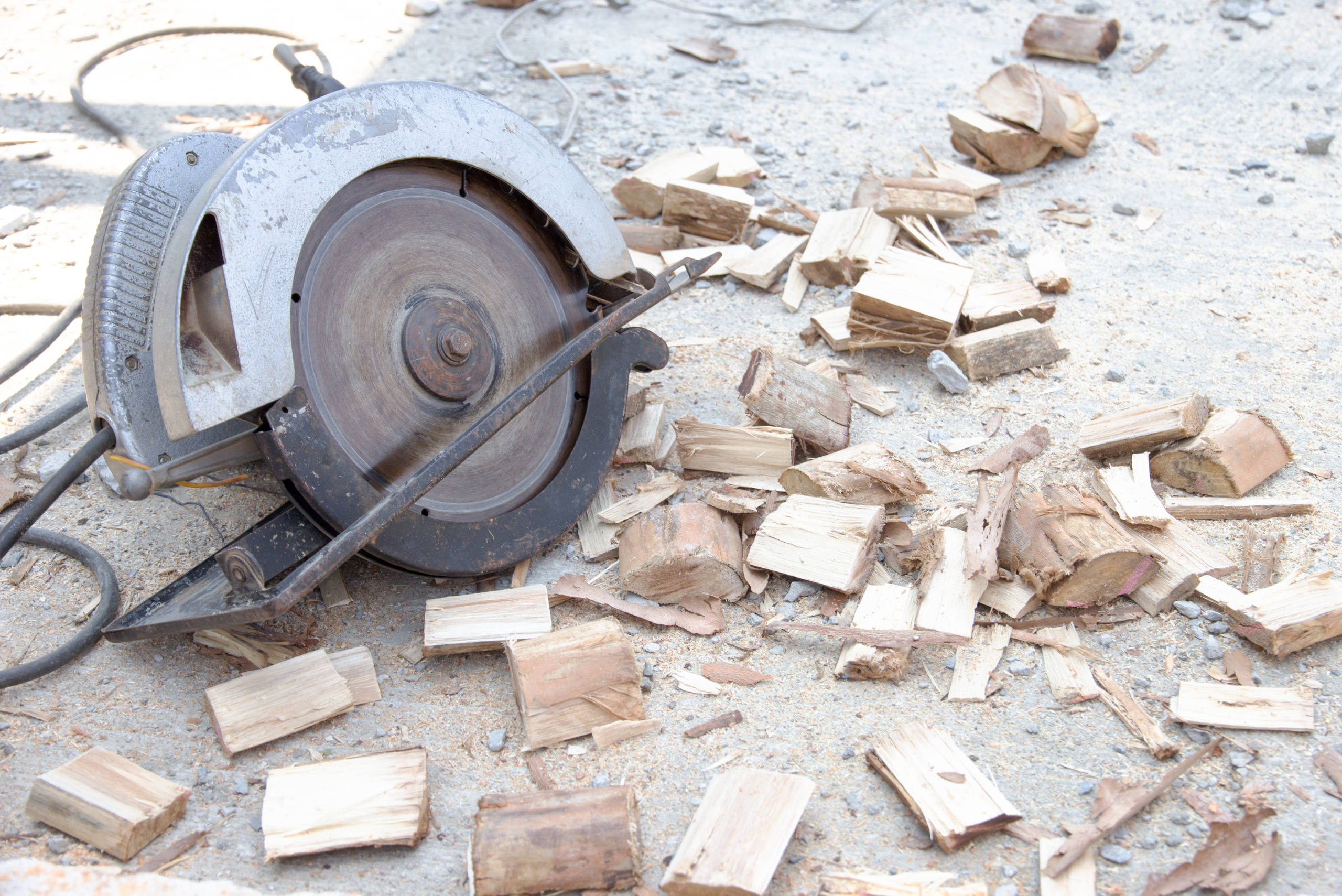 A circular saw on top of pieces of wood that were cut.