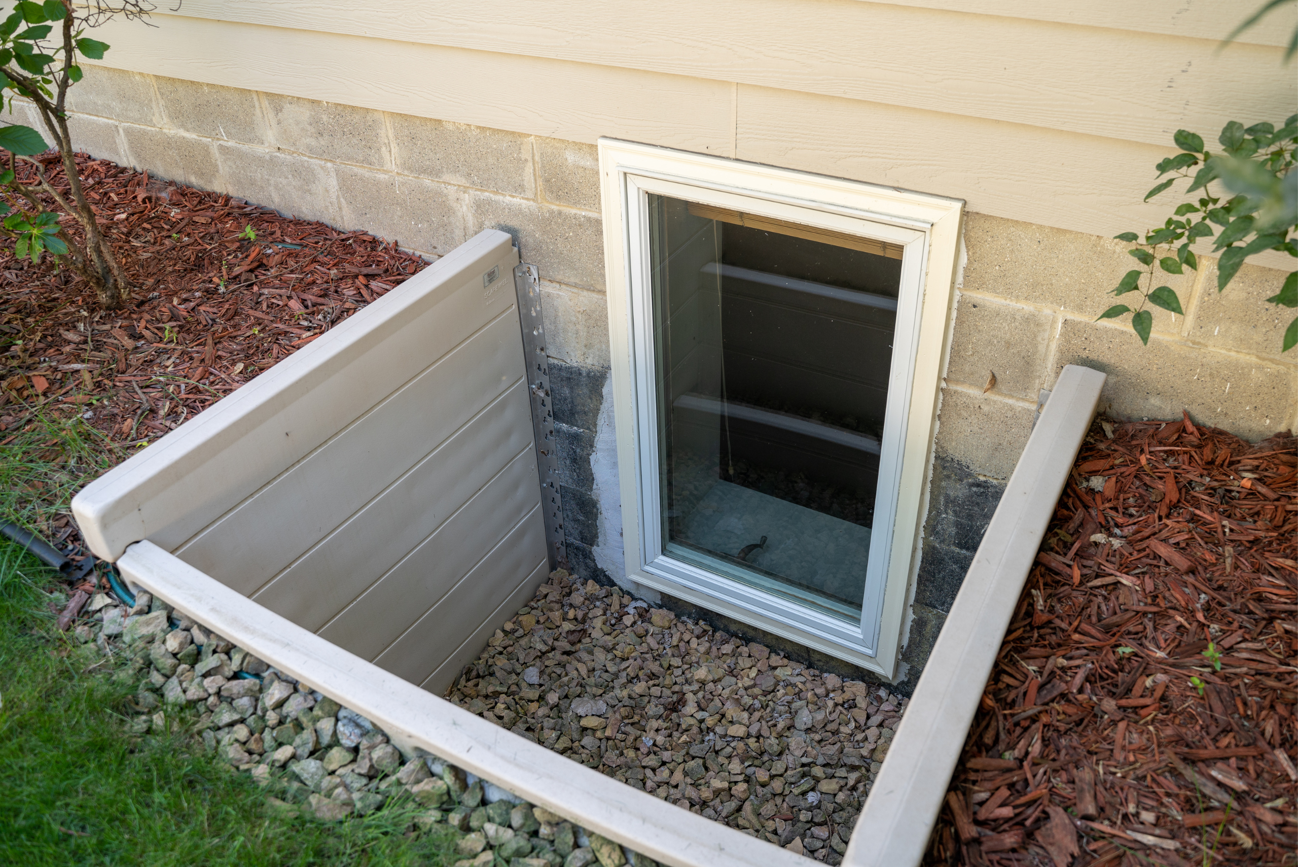 A basement window with dug out space for emergencies.