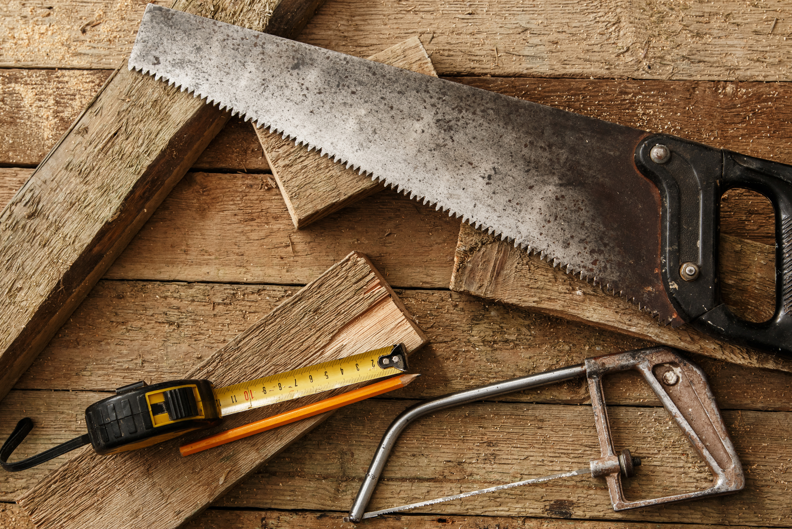 Saws and tools on top of wooden boards.