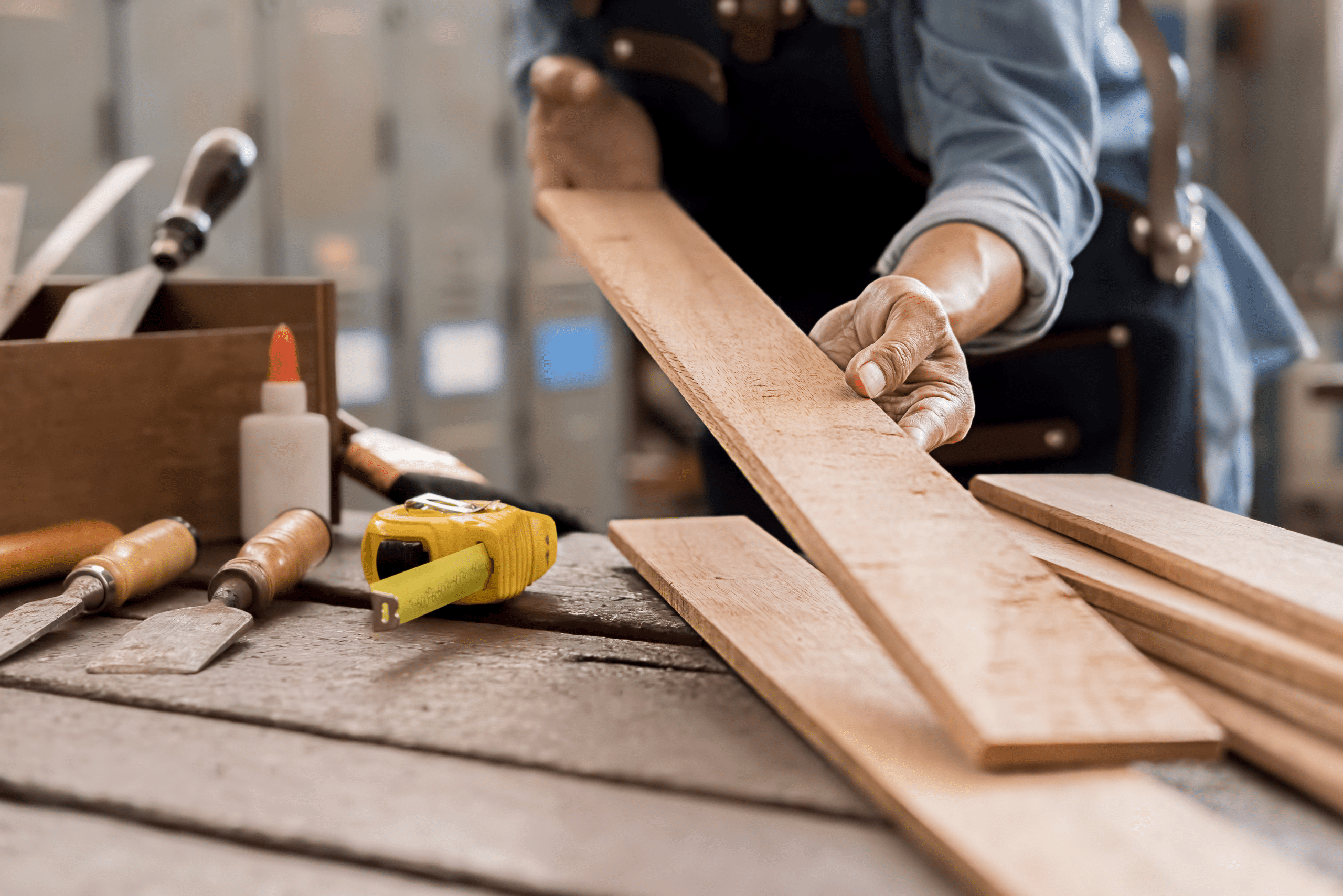 A person holding a wooden board with both hands.