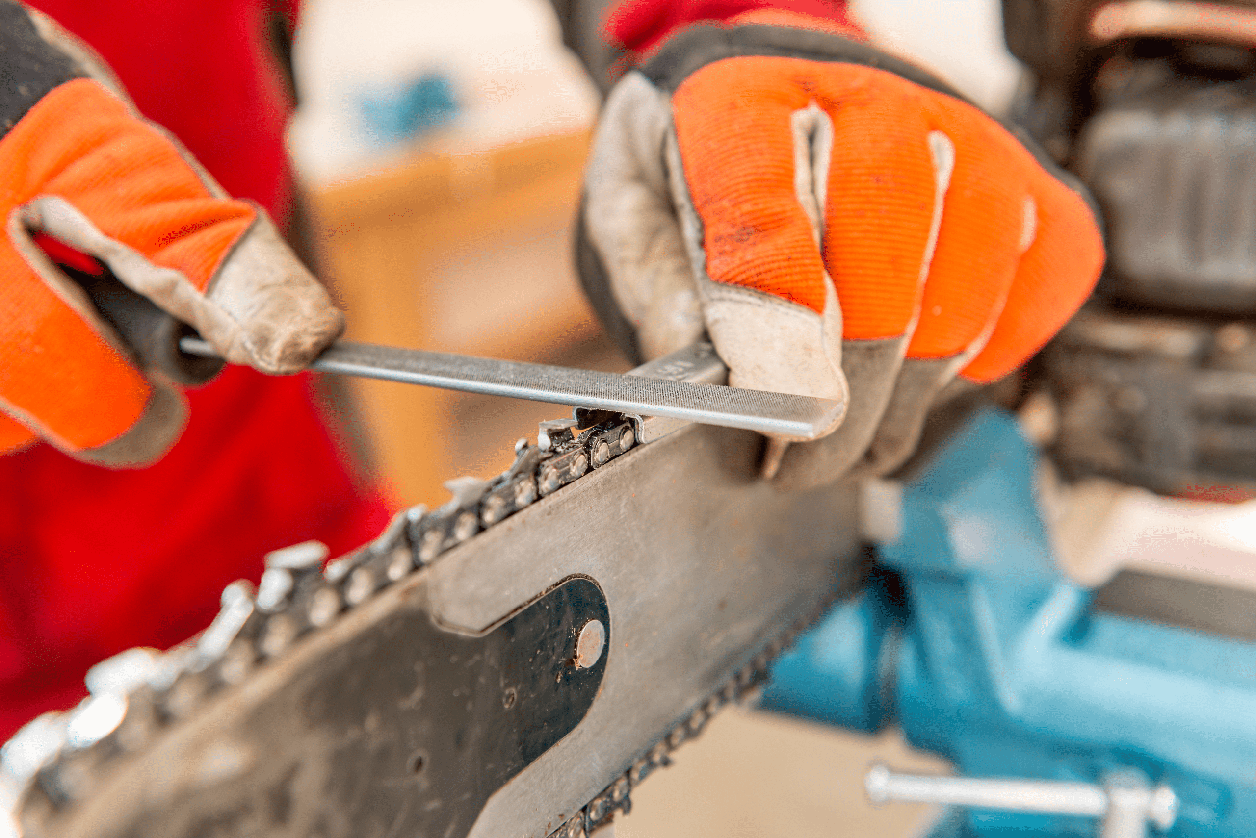 A closeup of someone's handing sharpening chainsaw chain.