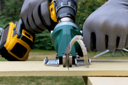 A hardie board being cut using a snapper power drill attachment.