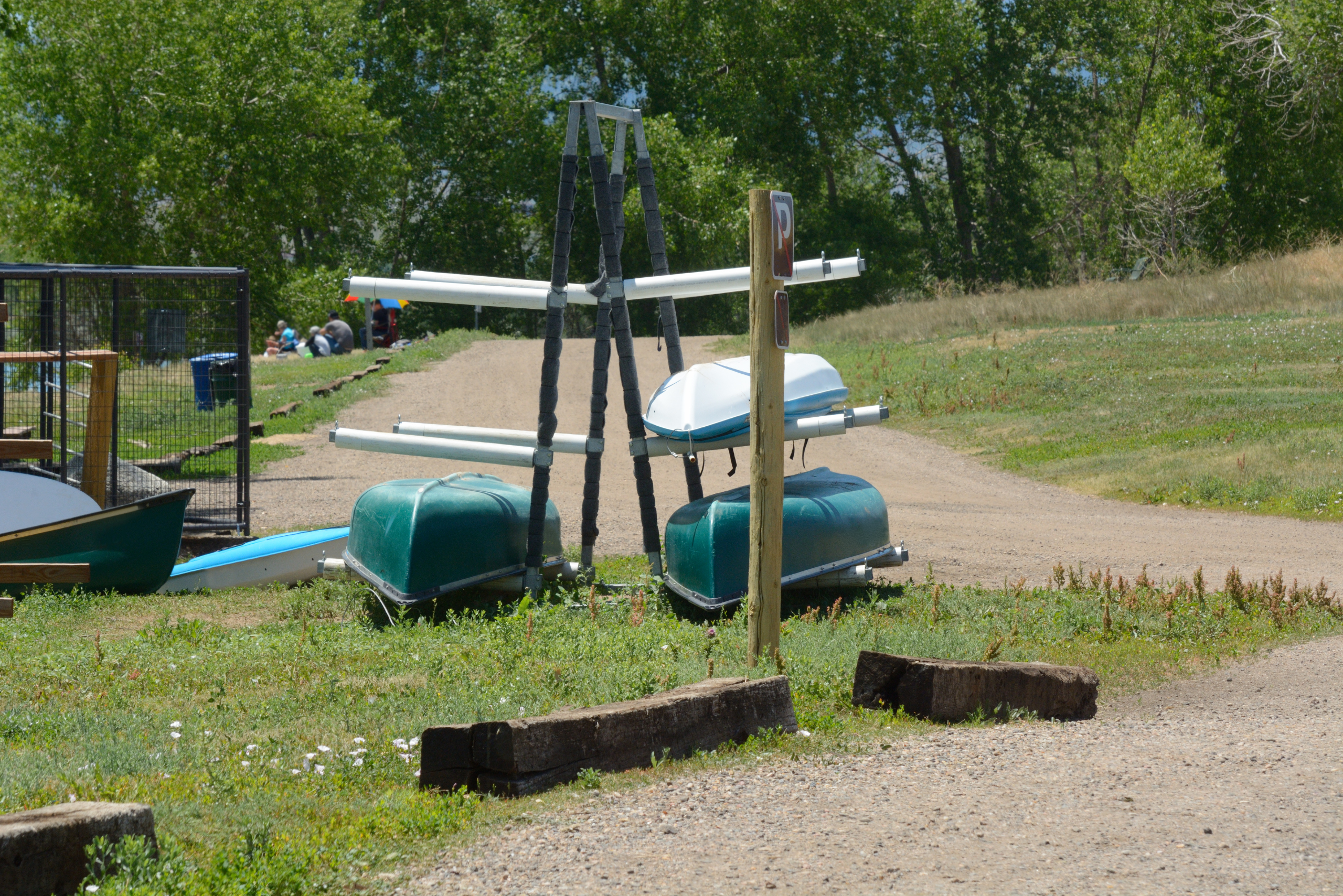 A metal DIY kayak rack with pool noodles for protection.