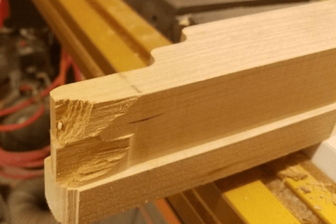 A piece of wood with a tear out from router use.