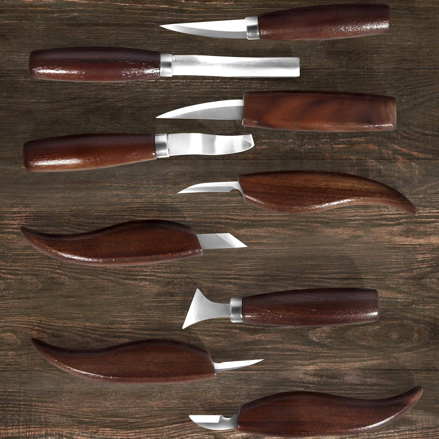 Whittling knives laid out on a wooden background.