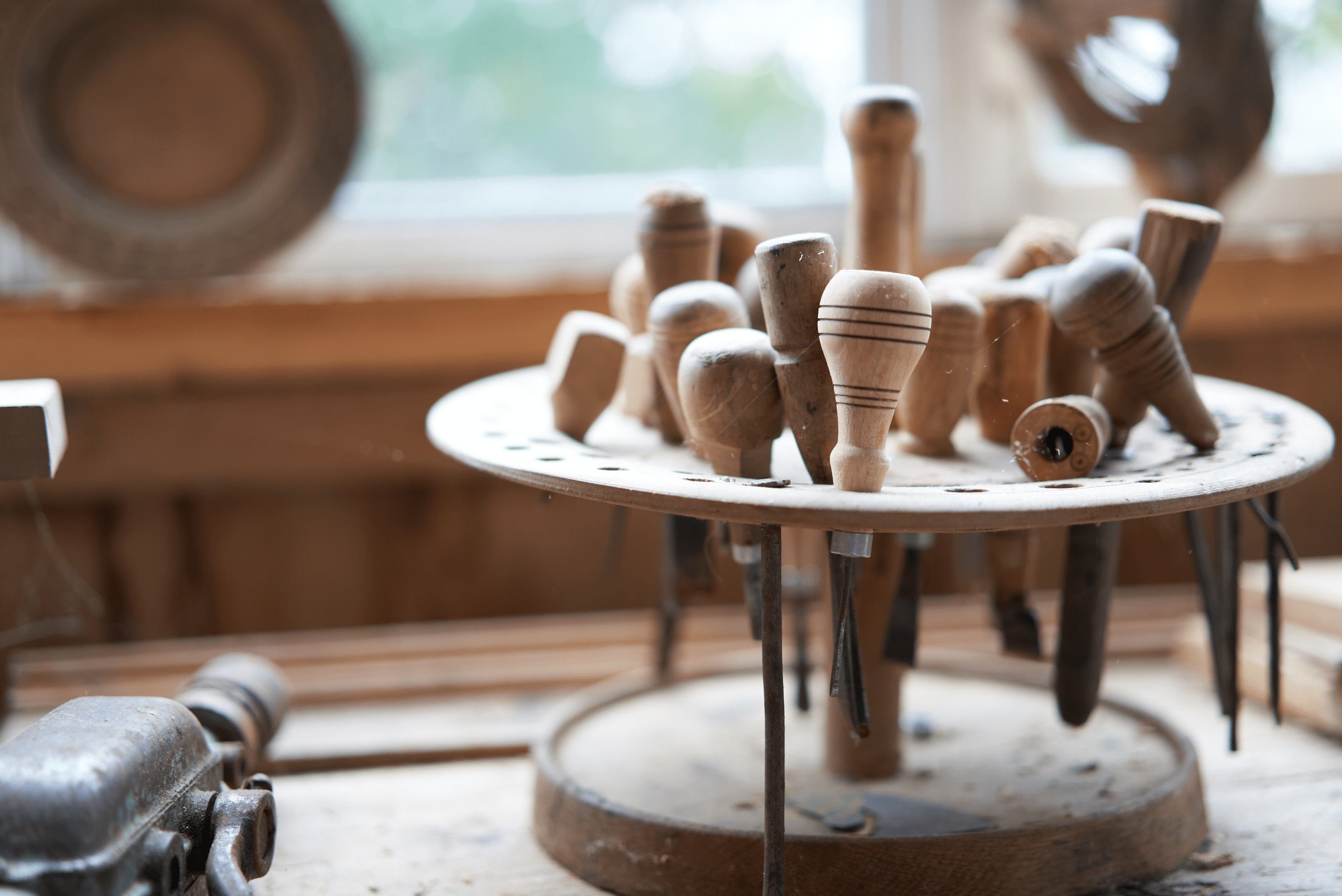 A selection of wood carving tools in a rotatable holder.