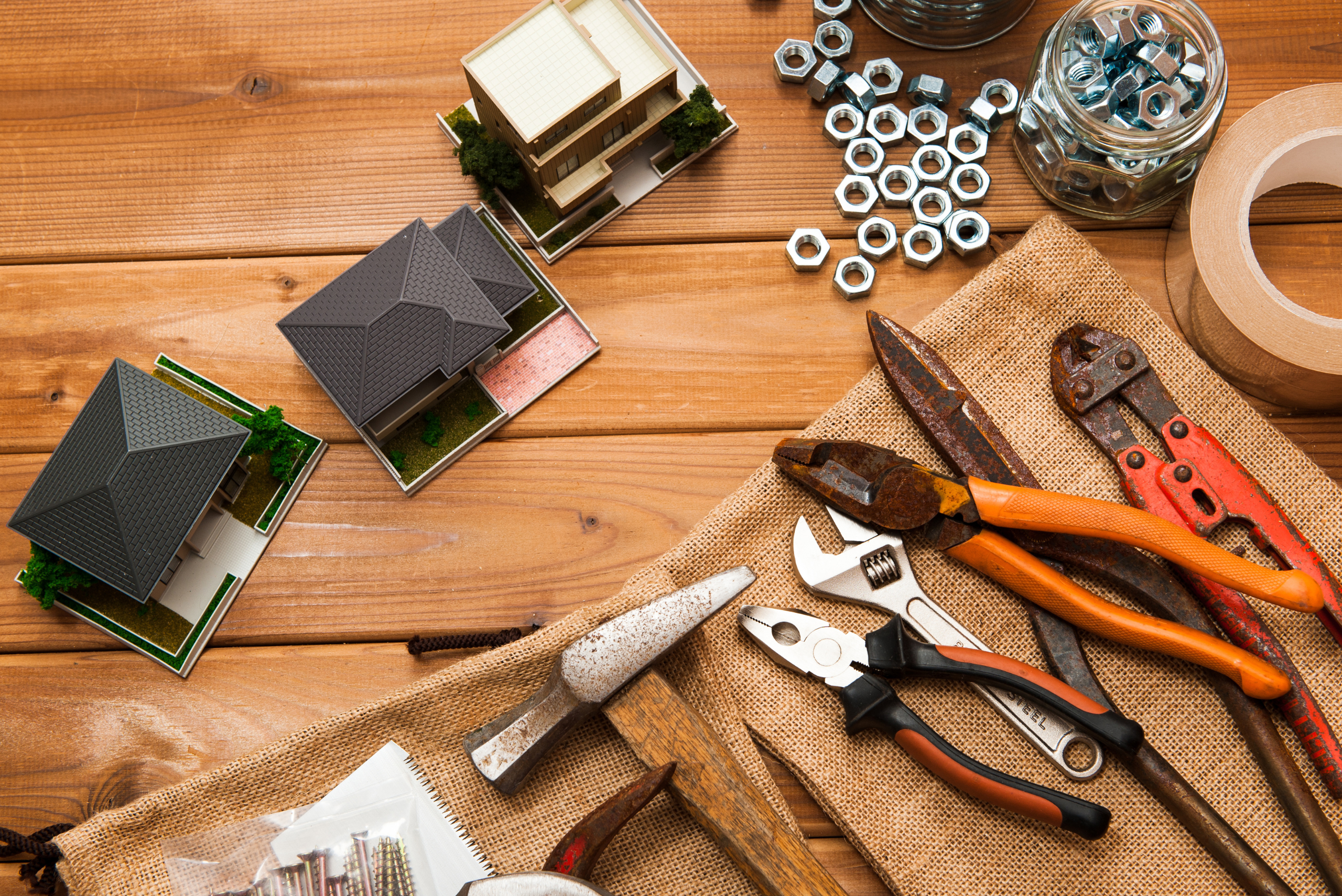An assortment of tools on a wooden background.