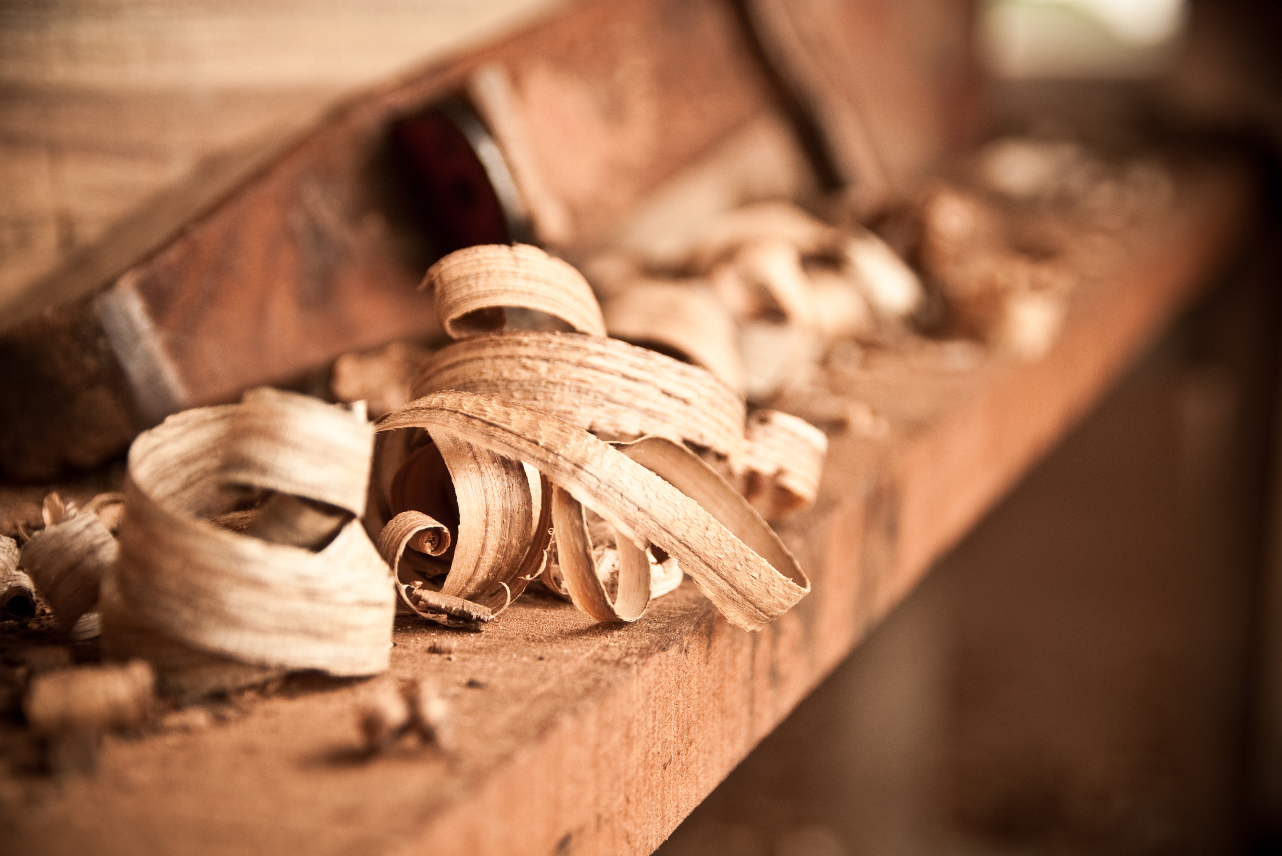 A bunch of wooden shavings on a wooden table.