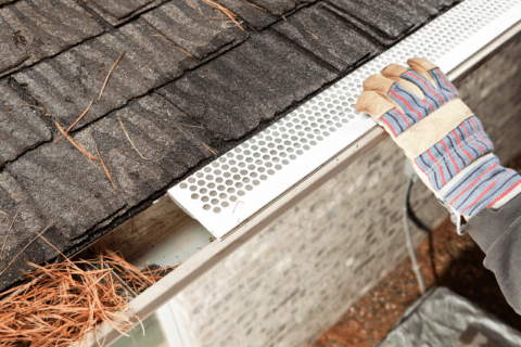 A closeup of someone installing gutter guards.