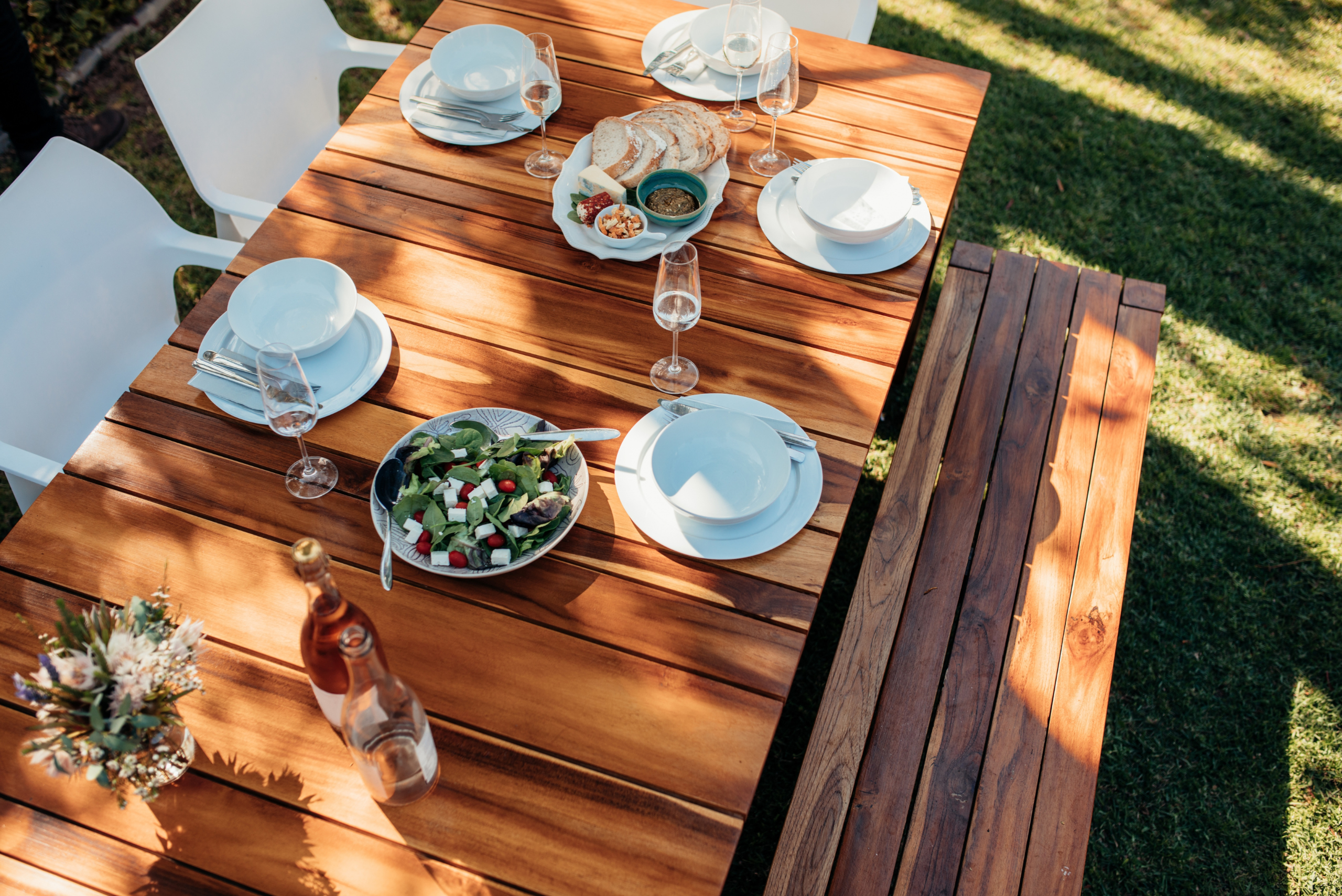 Wooden dining table with dishes and food.
