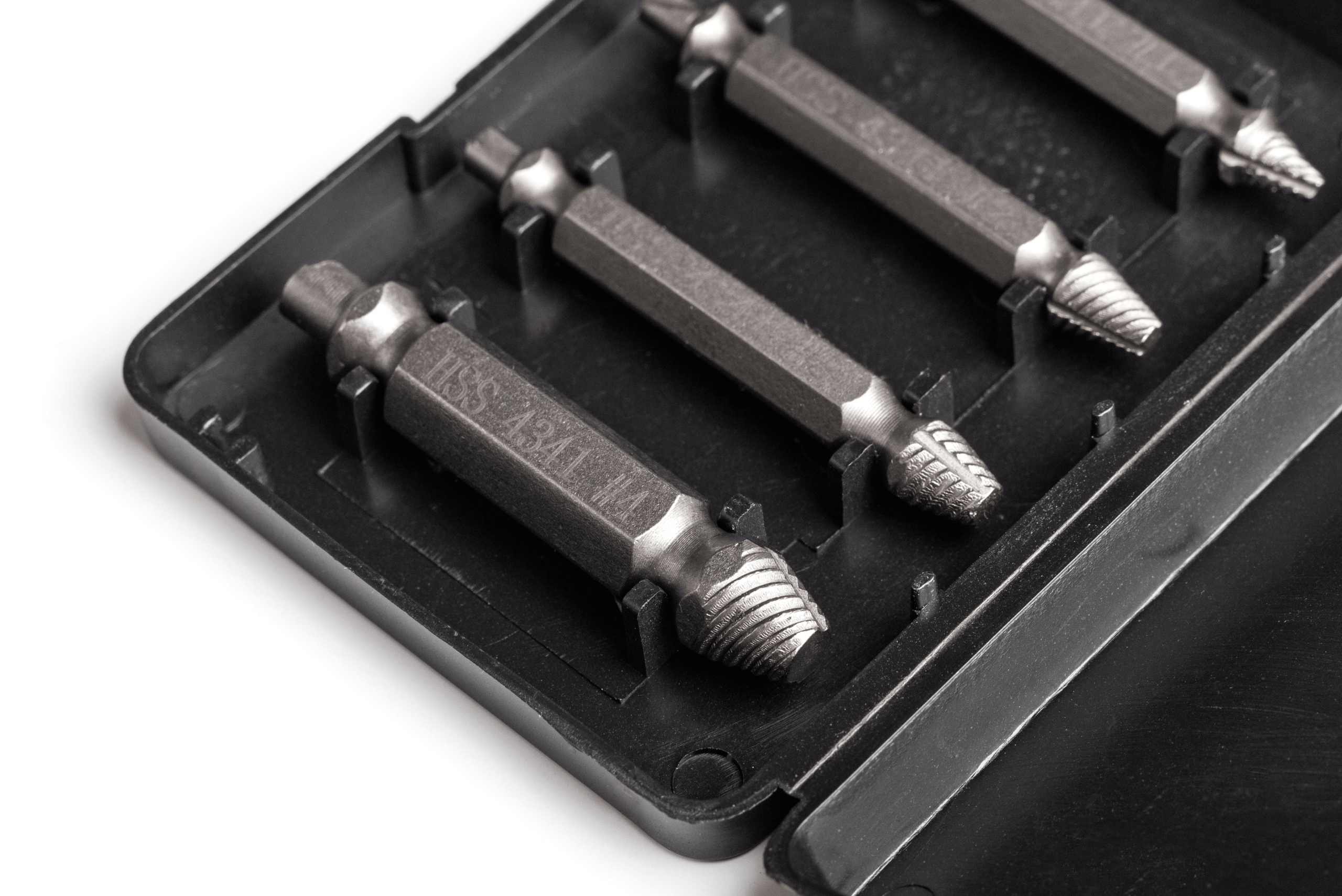 A set of screw extractors in a black plastic holder.