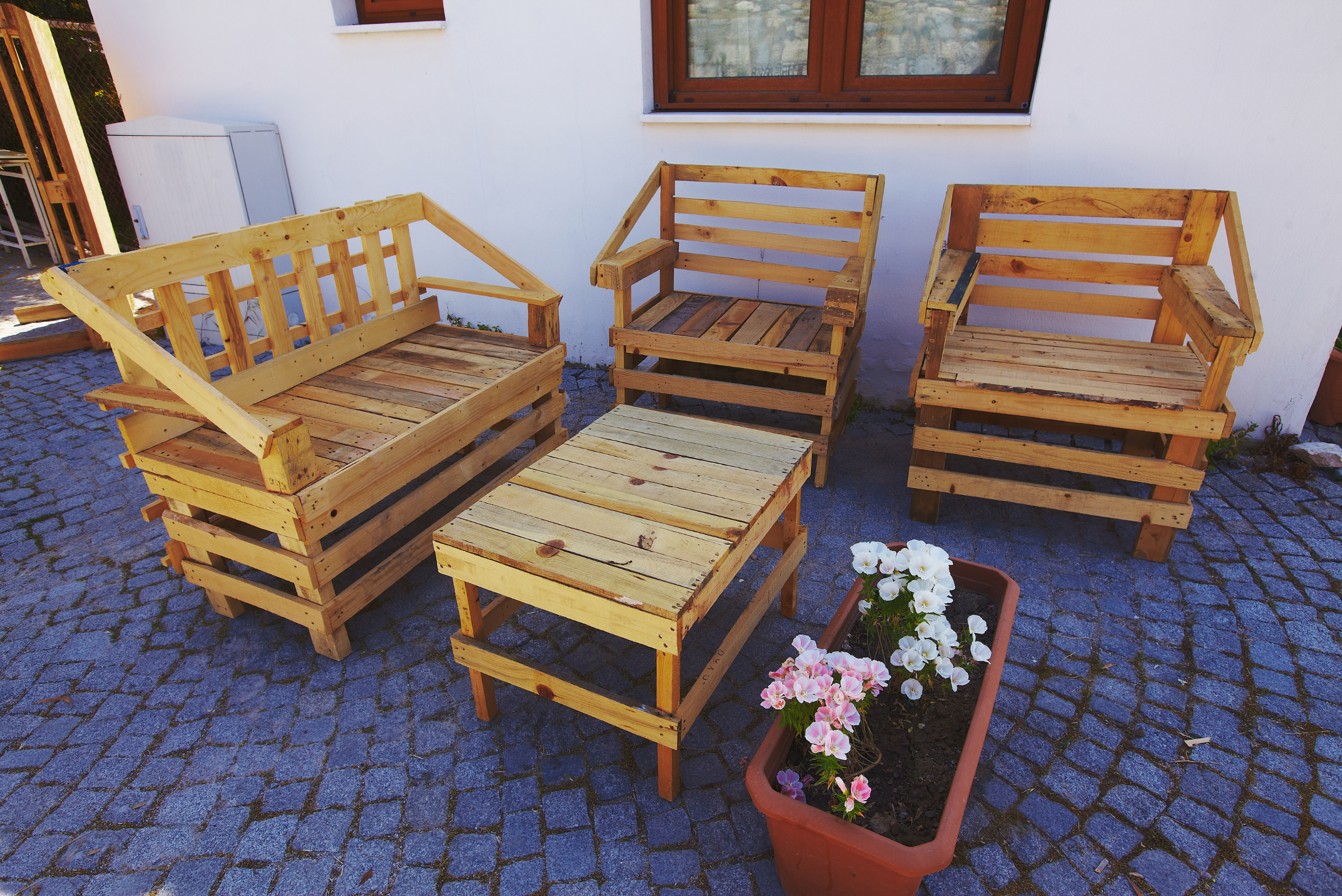 A wooden outdoor coffee table made of pallets