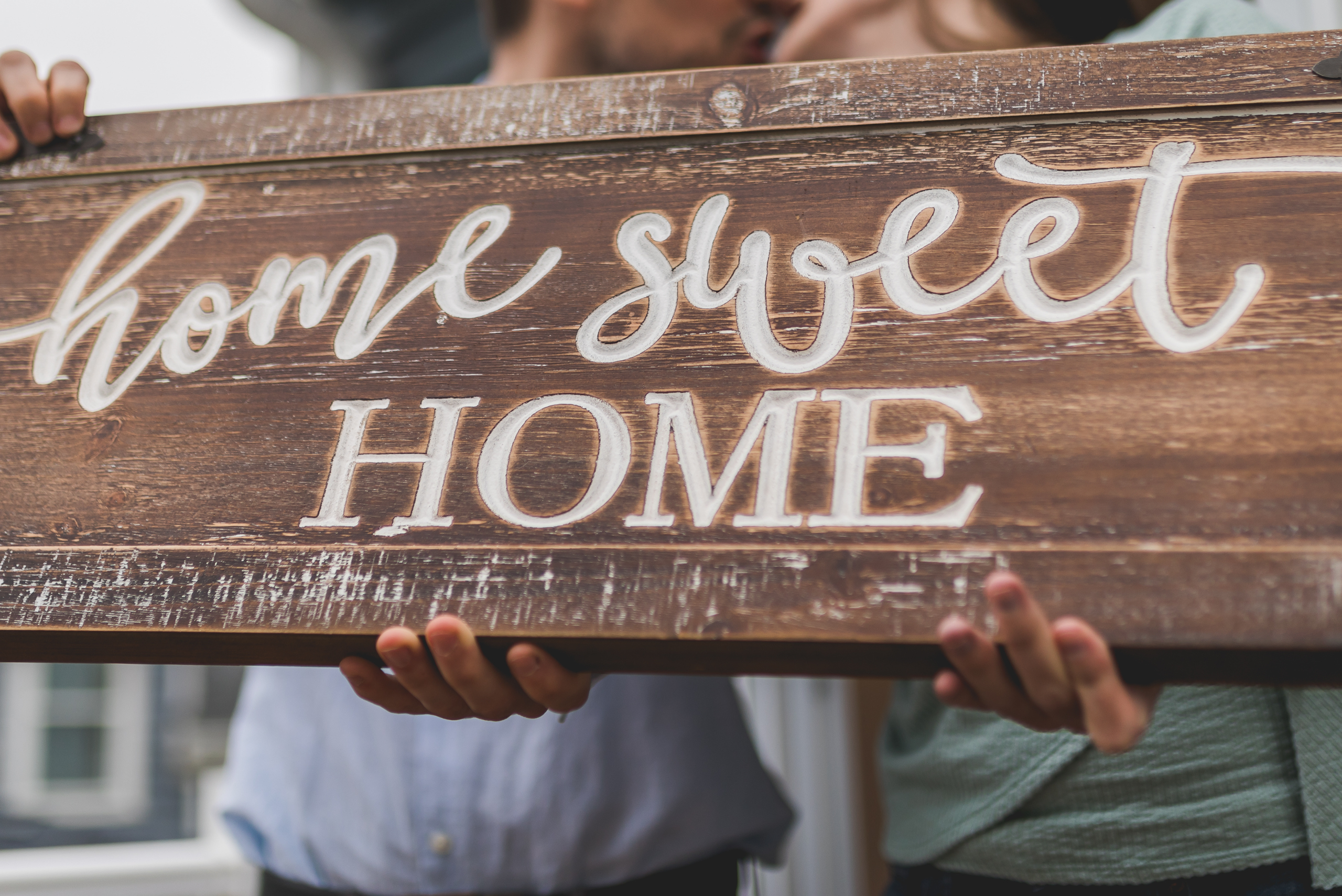 A wooden sign that reads "home sweet HOME"