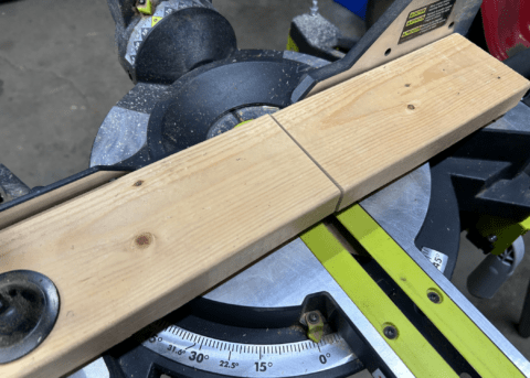 a cross cut through a piece of wood that is sitting on a mitre saw