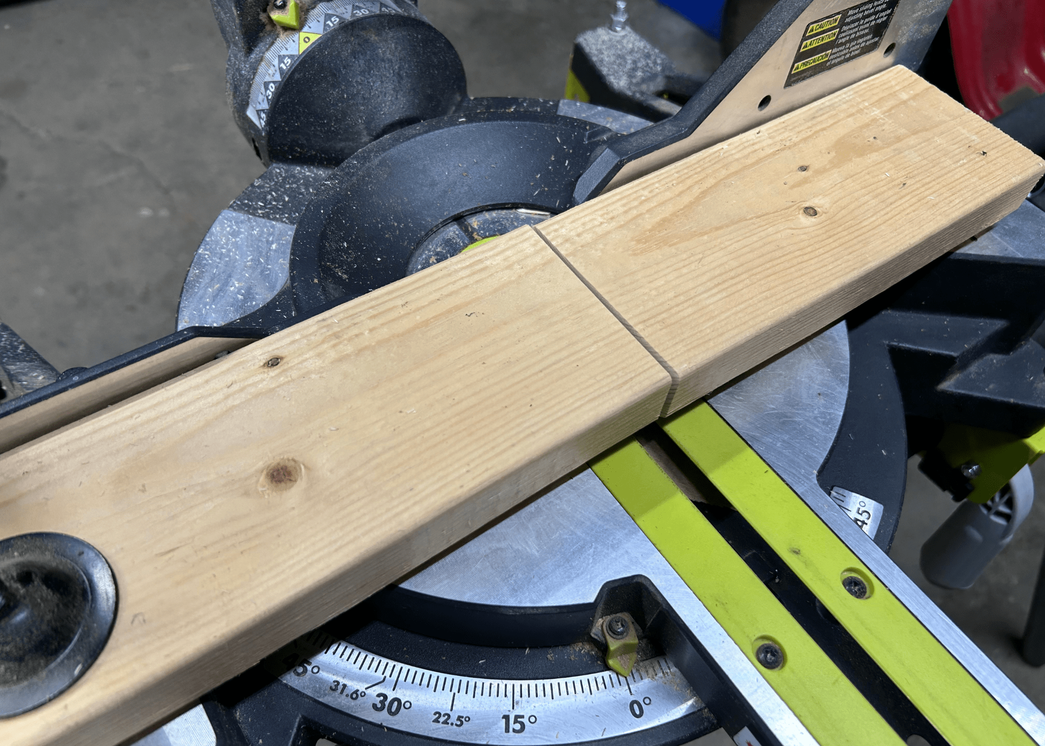 a cross cut through a piece of wood that is sitting on a miter saw