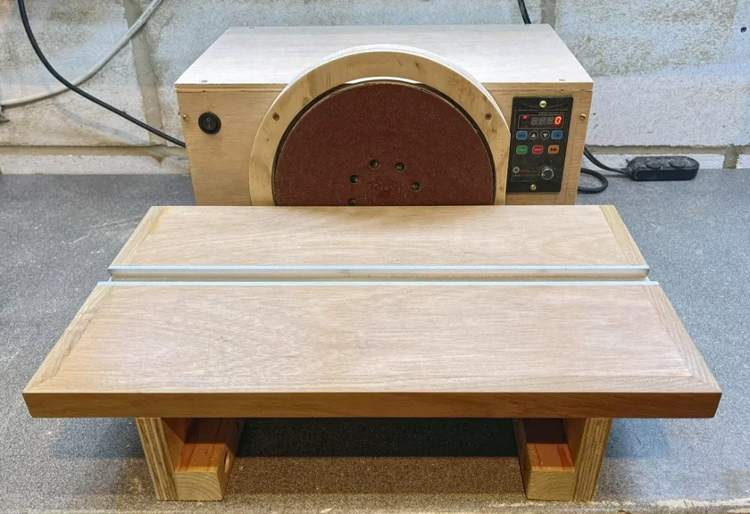 A DIY bench disk sander made with wooden platform.